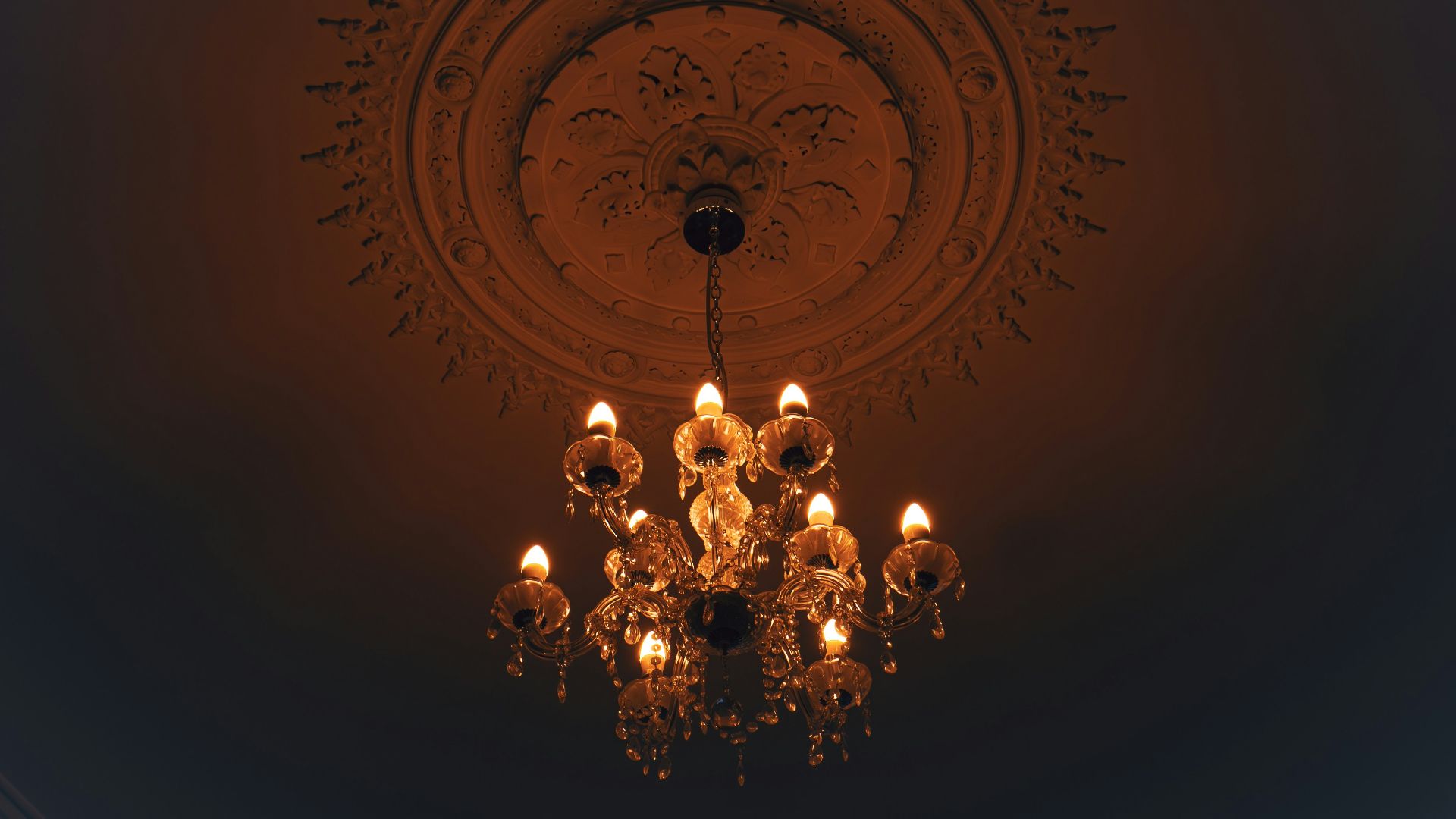 a chandelier hanging from the ceiling in a dark room