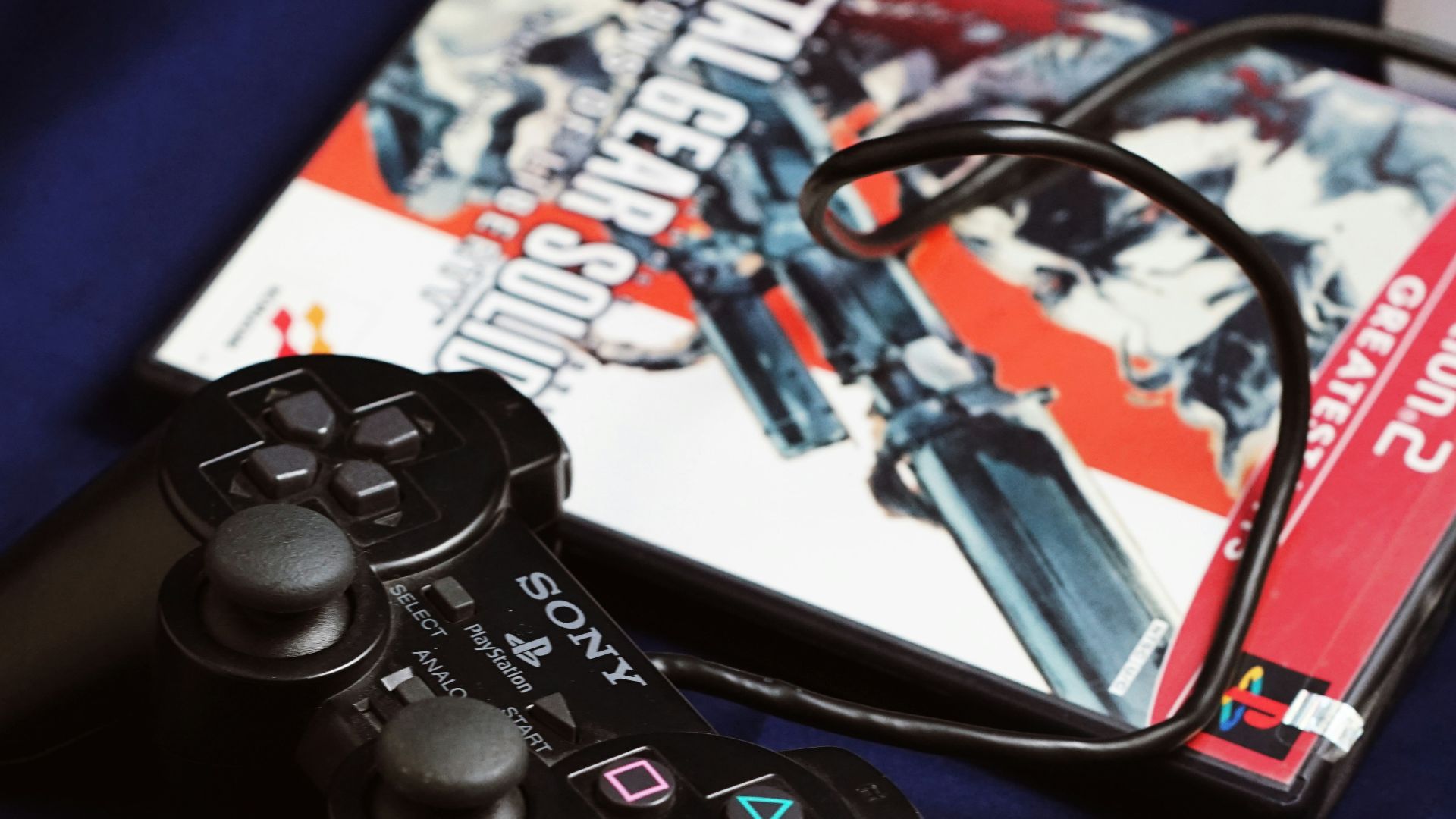 a couple of video game controllers sitting next to a dvd