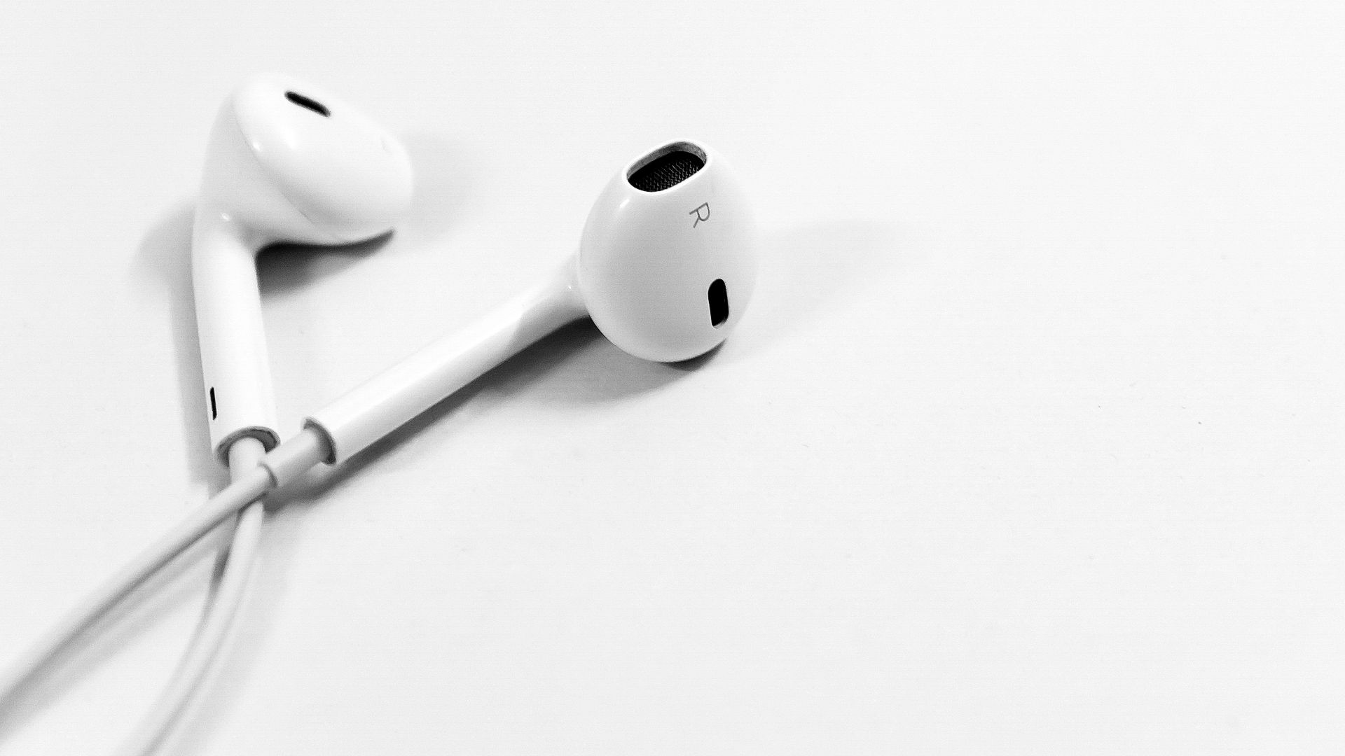 Apple AirPods on white surface