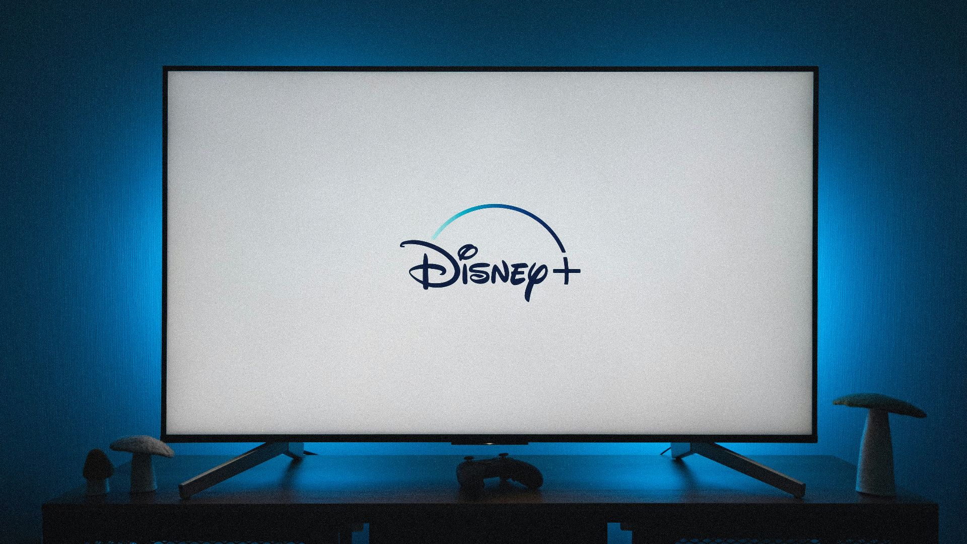 a flat screen tv sitting on top of a wooden table