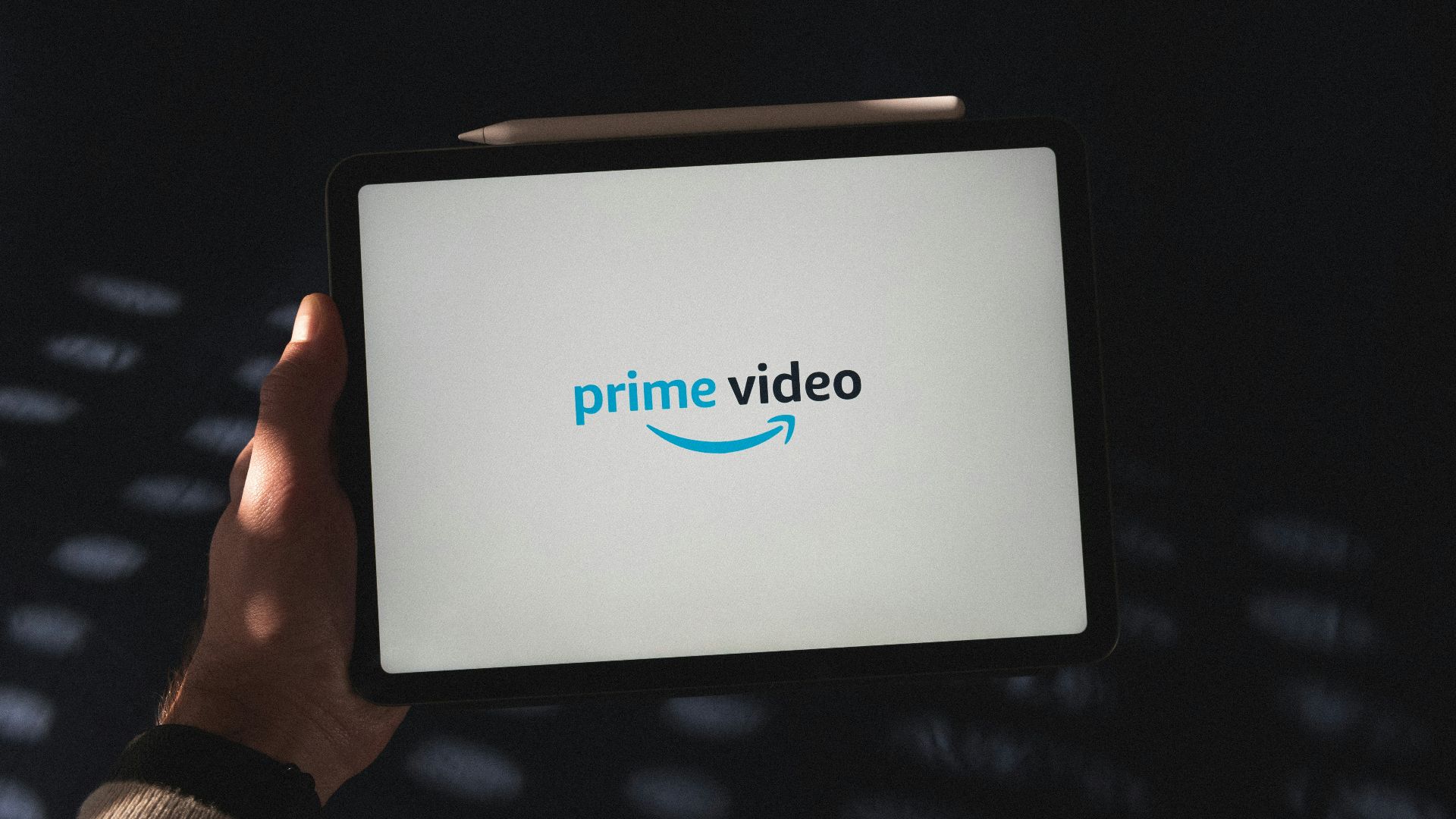 a person holding a tablet with a logo on it