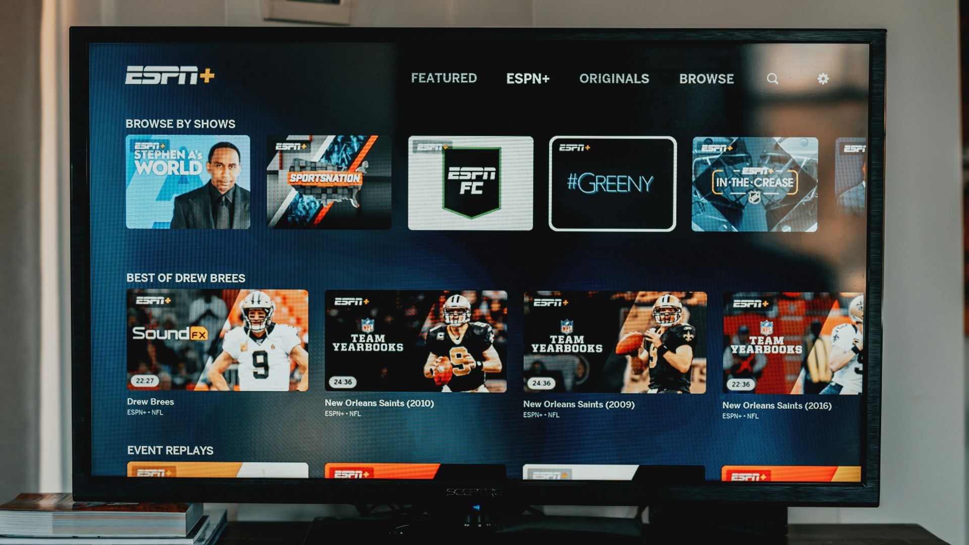 a flat screen tv sitting on top of a wooden table