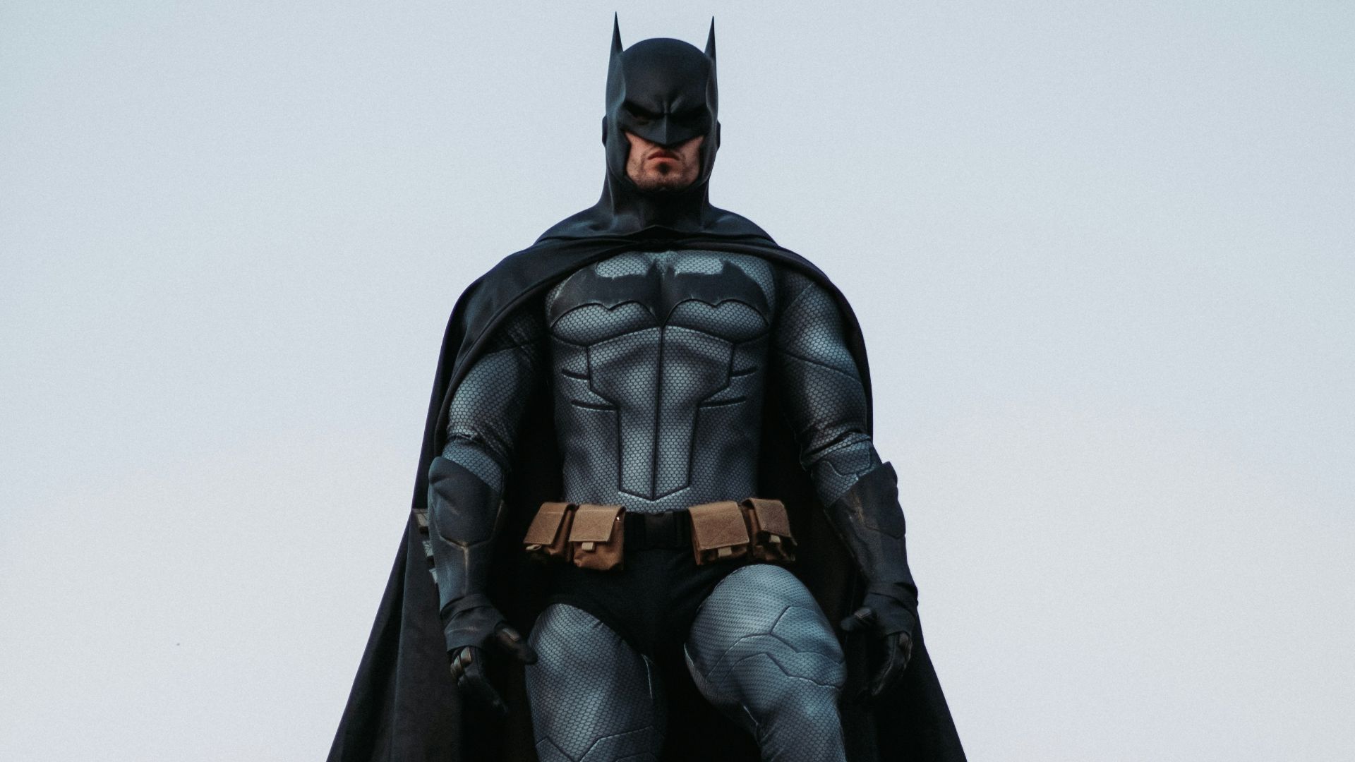 man in black jacket and pants standing on roof