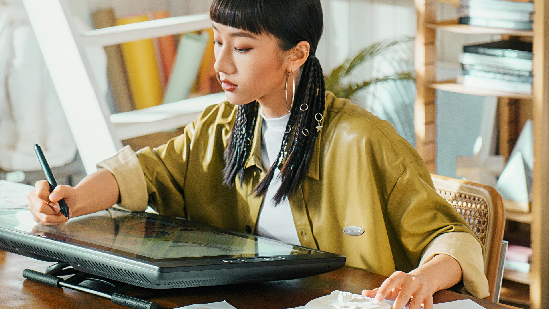 Artist works on a digital tablet in her studio.