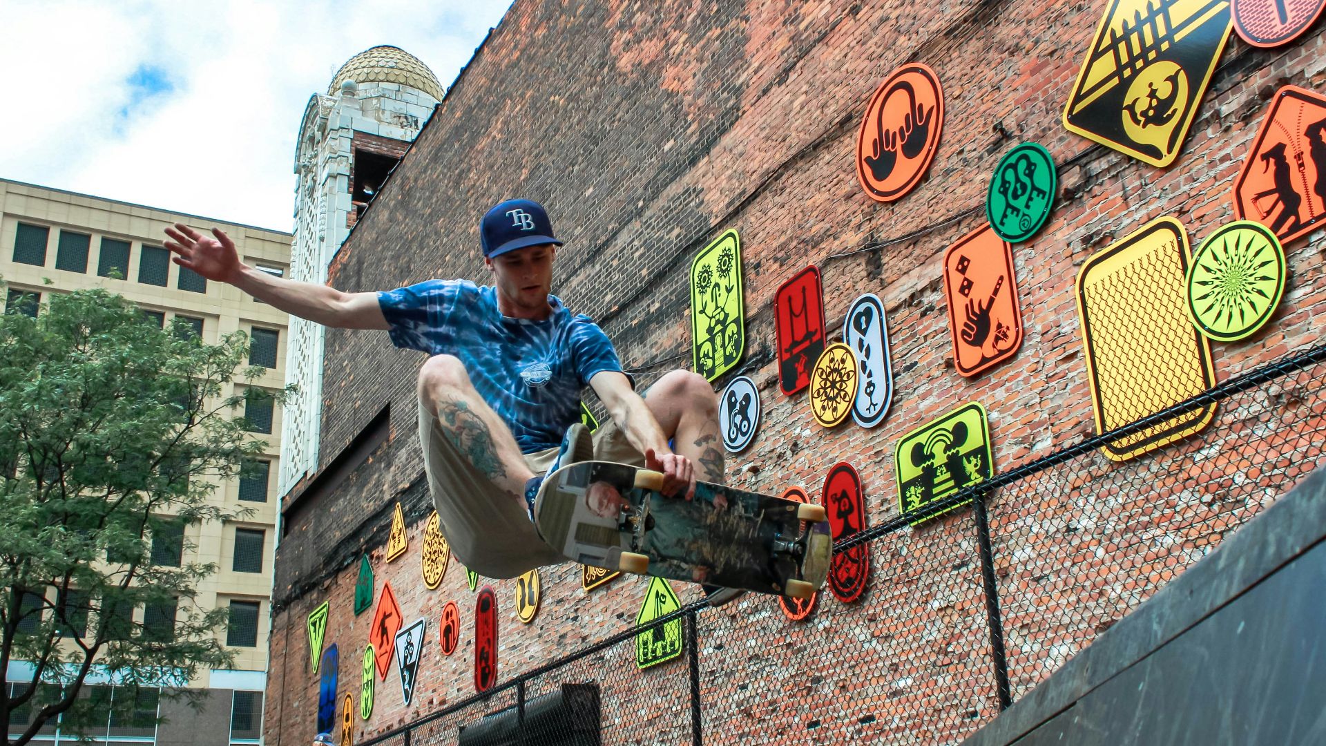 man skateboarding near brown concrete building during daytime
