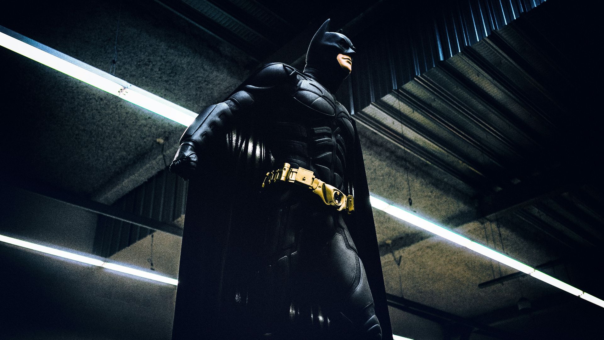 Batman standing under steel roof