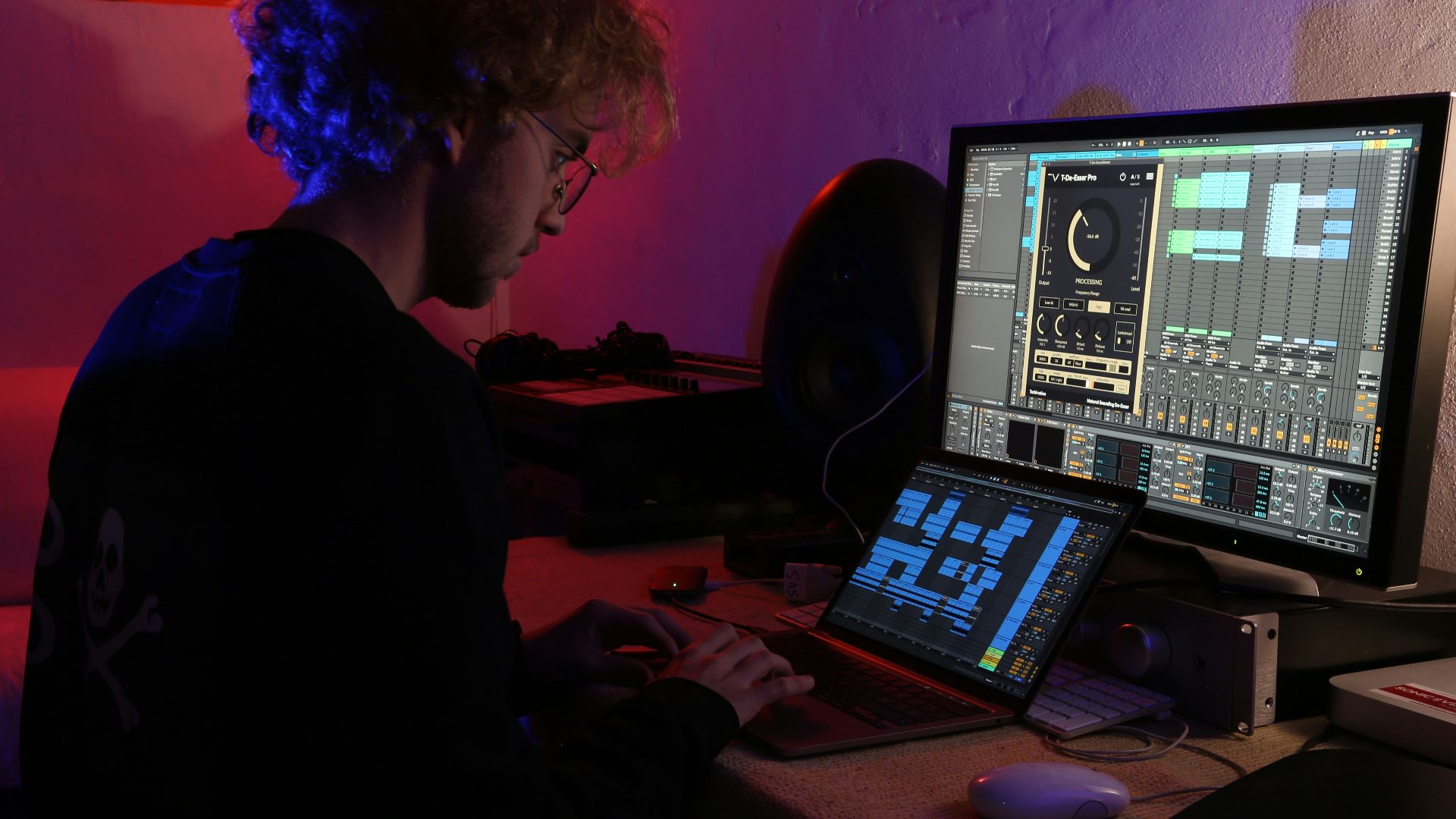 a man sitting in front of a computer monitor