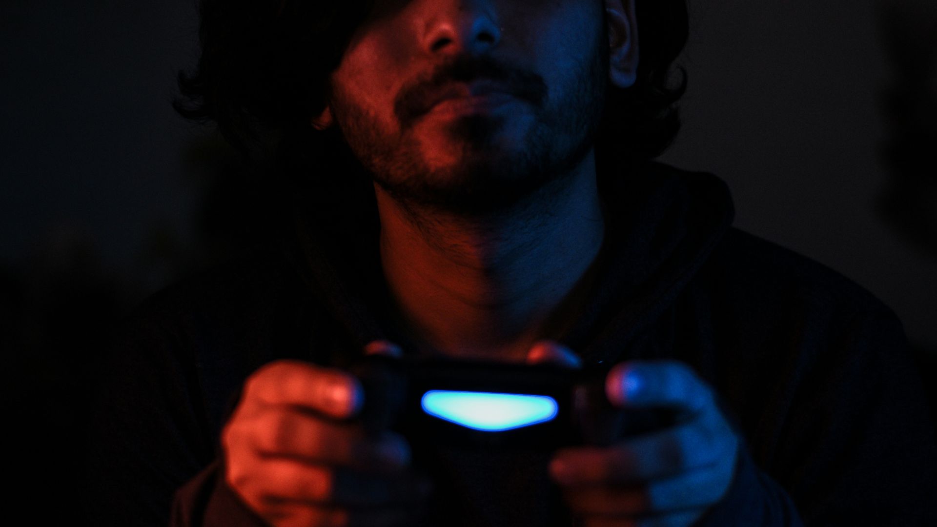 man in black jacket holding black smartphone