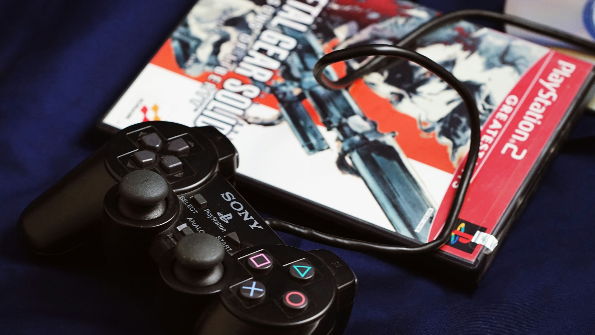 a couple of video game controllers sitting next to a dvd