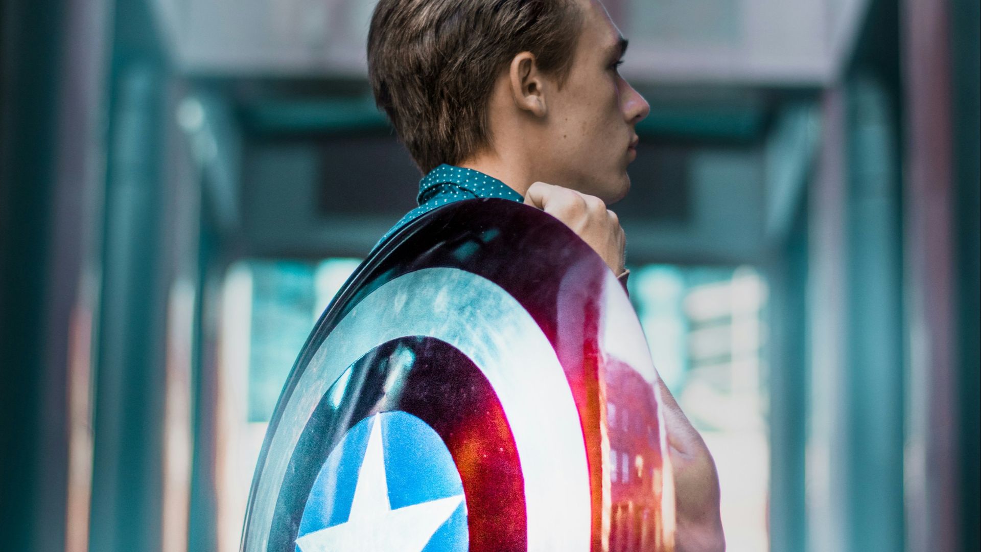man carrying Captain America's shield