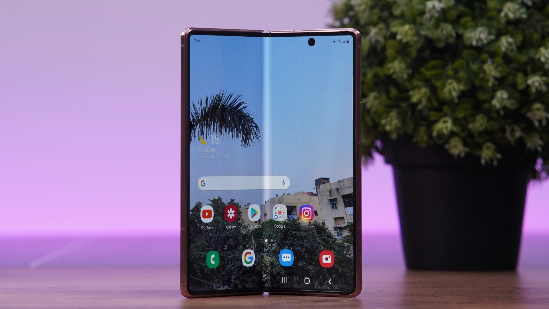 a cell phone with a tree in the background