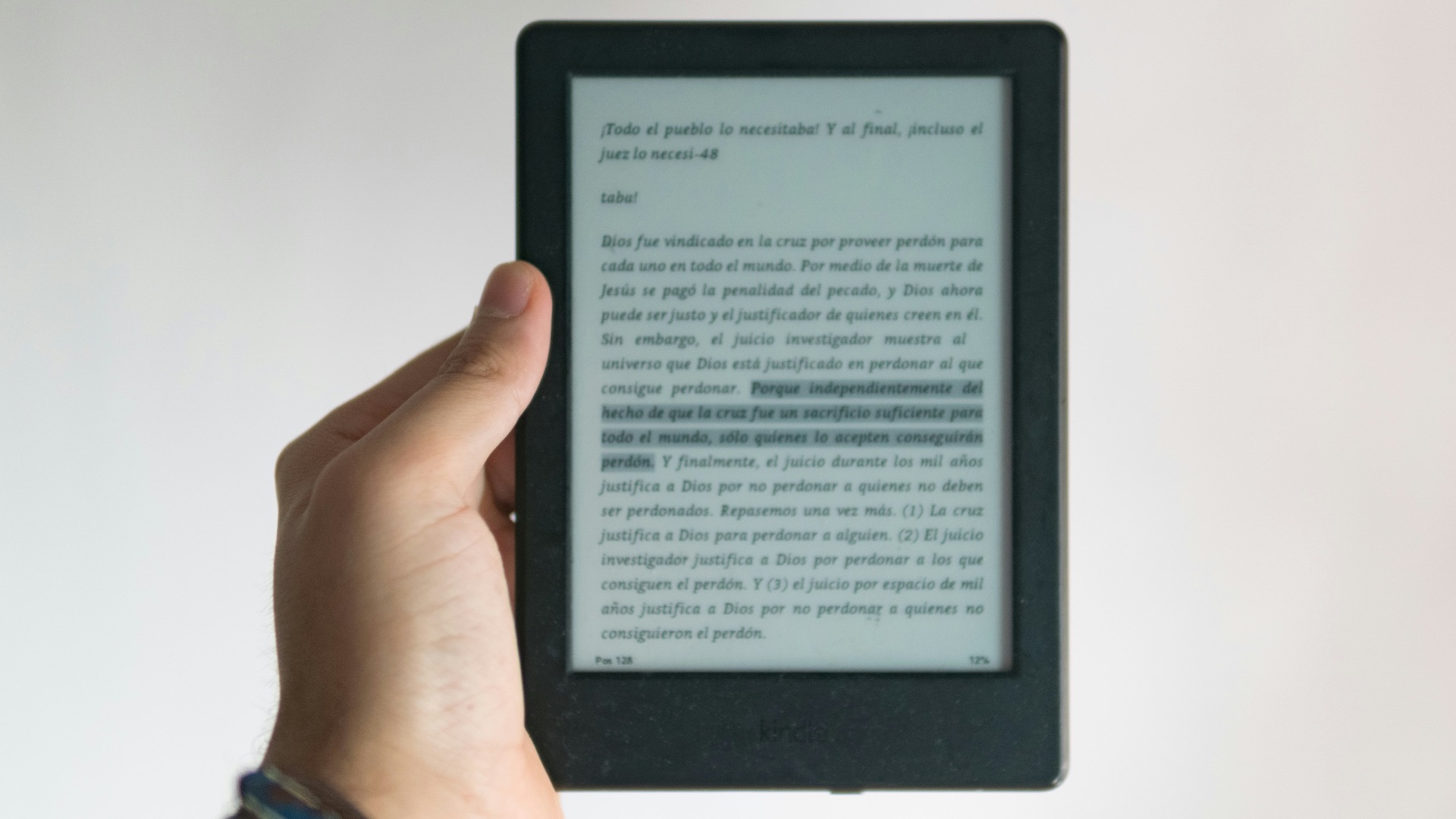 person holding black e book reader