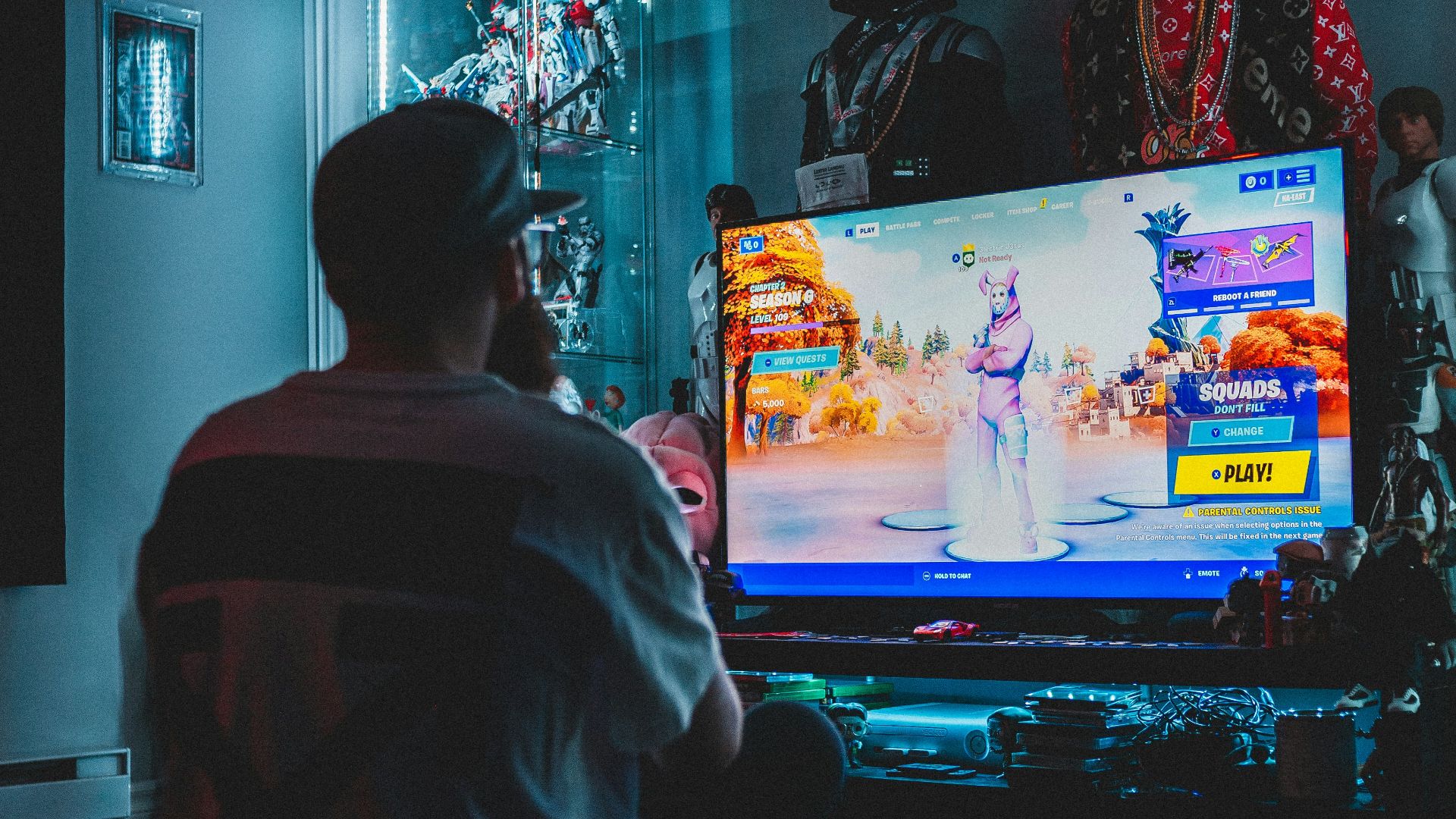 man in red shirt watching tv