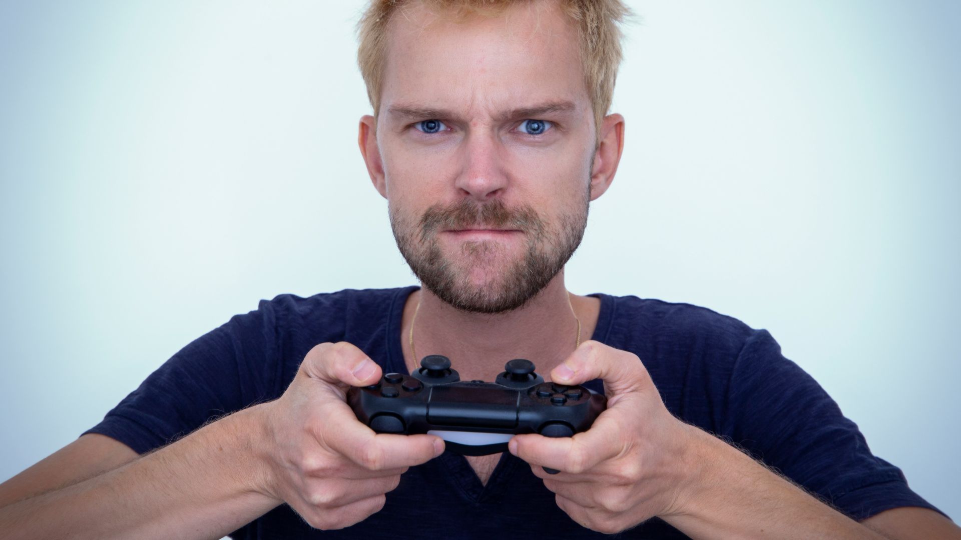 man in blue long sleeve shirt holding black semi automatic pistol