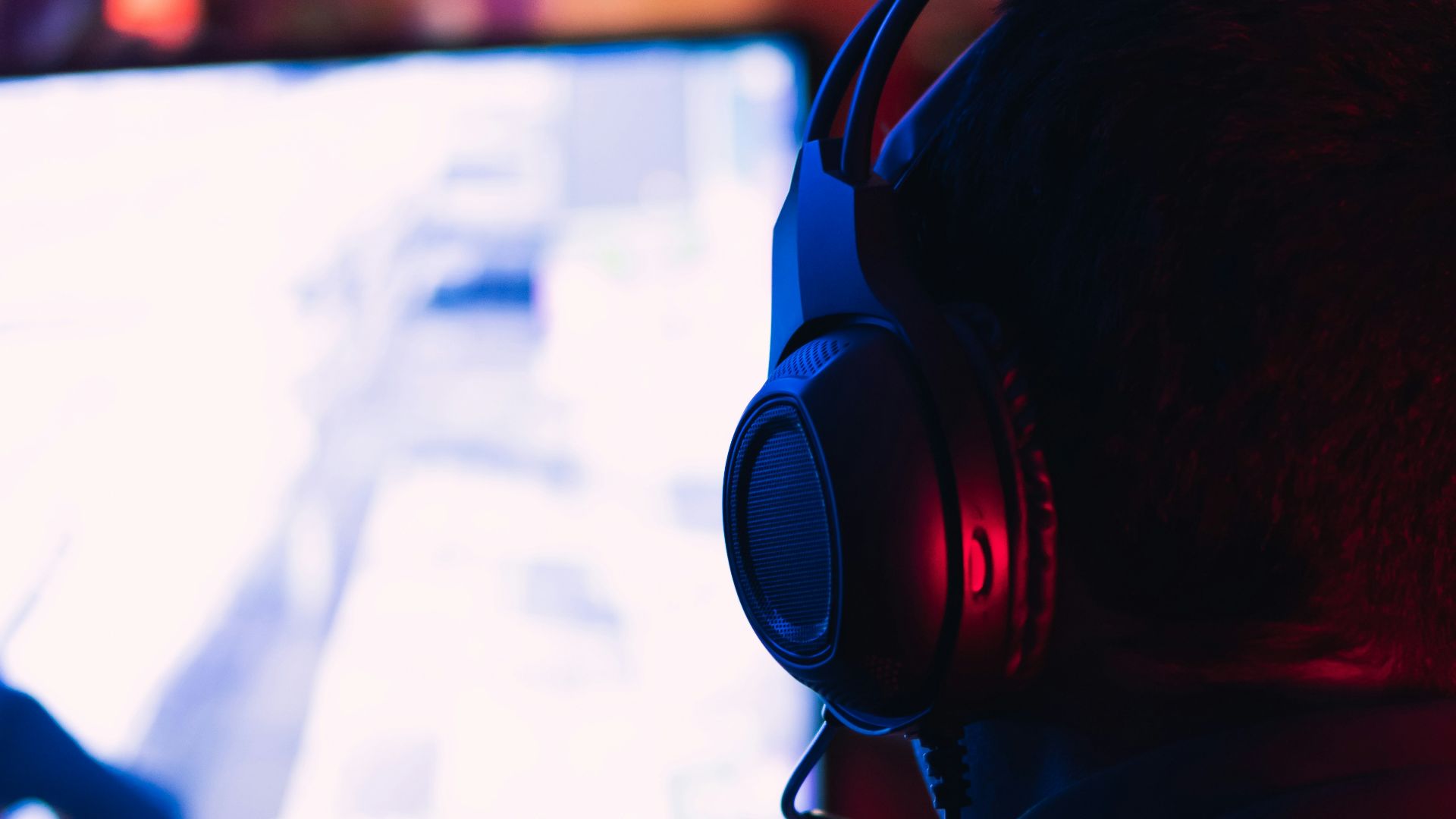 man in red shirt wearing black headphones