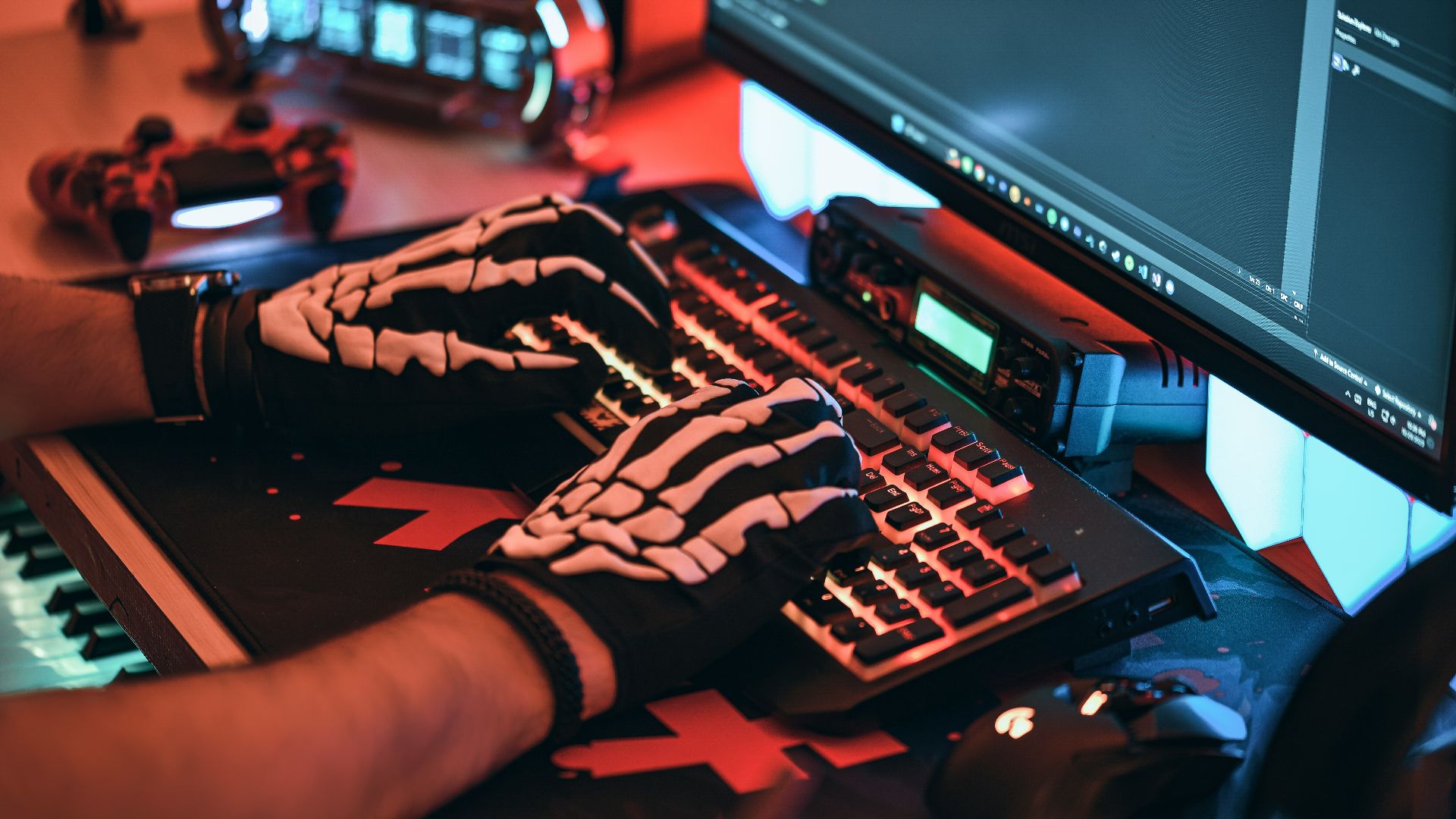 a person wearing a skeleton glove typing on a keyboard