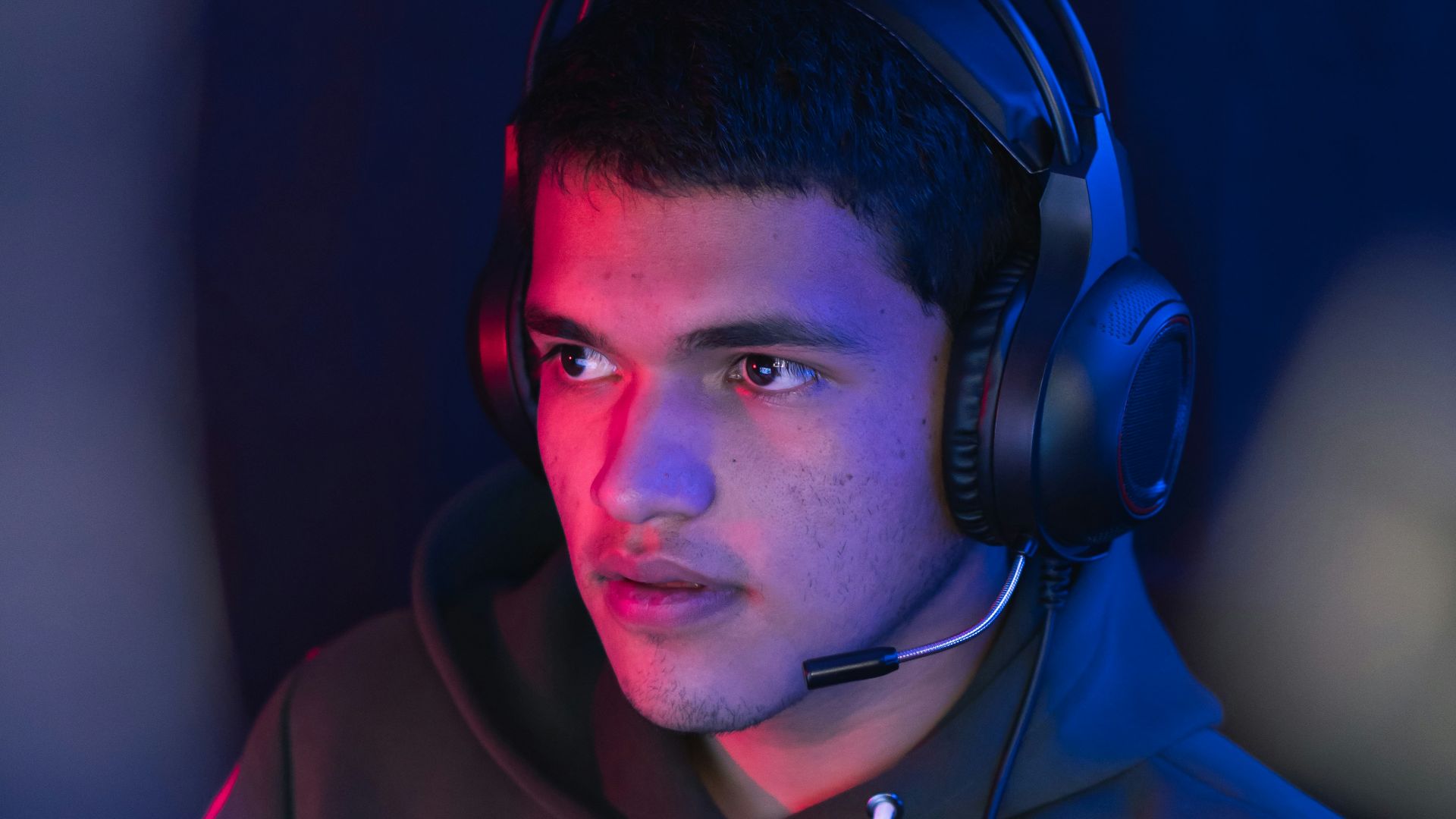 man in blue hoodie wearing black headphones