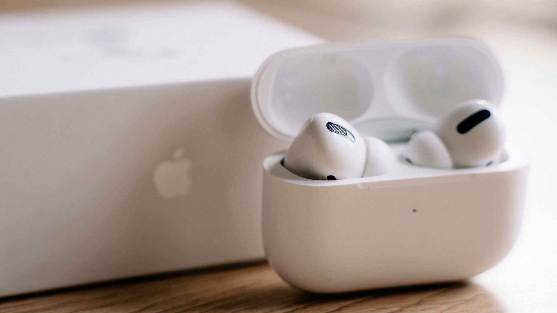 white apple earpods in white plastic case
