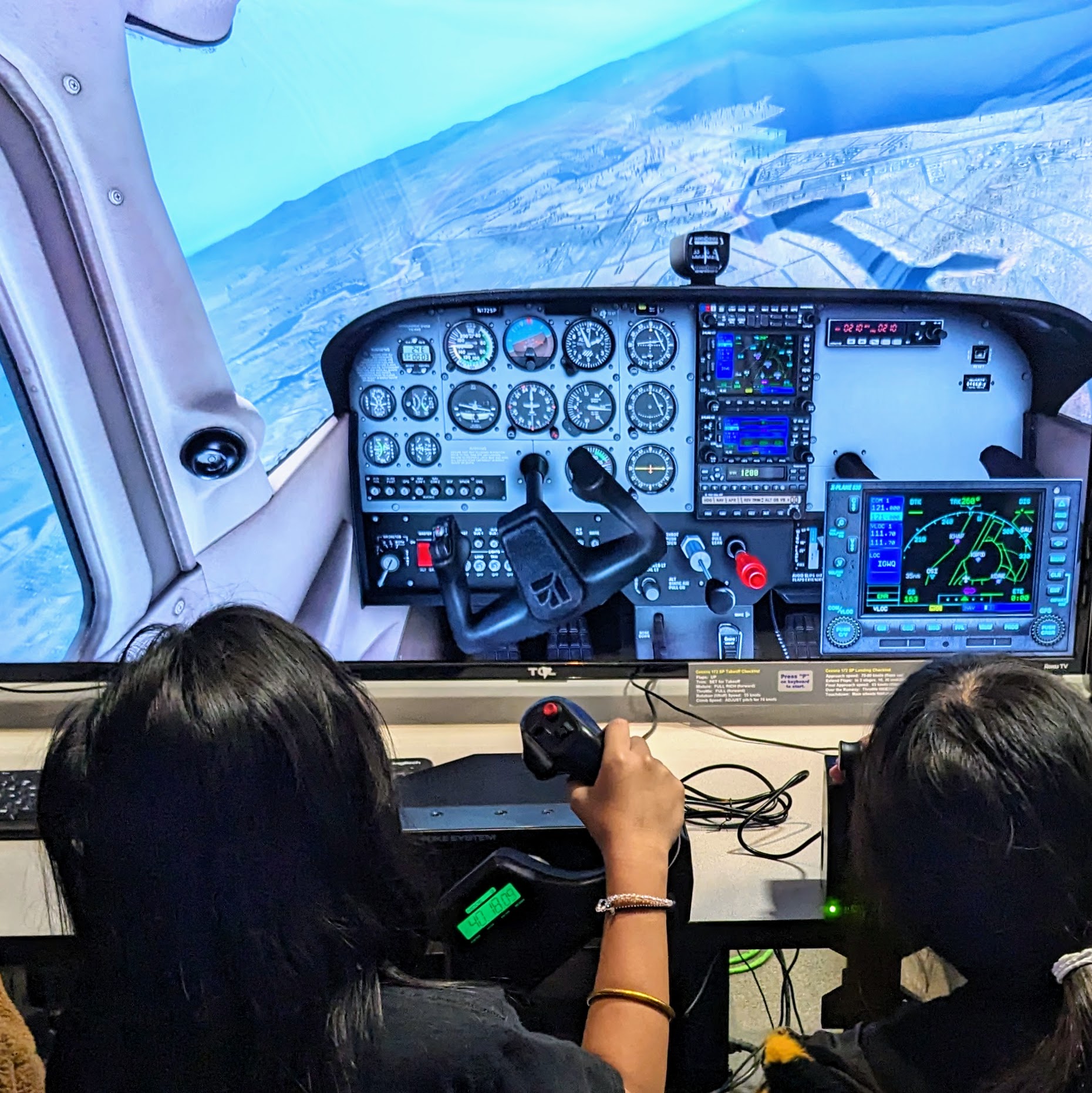 Visitors_using_a_desktop_flight_simulator_at_Hiller_Aviation_Museum.jpg