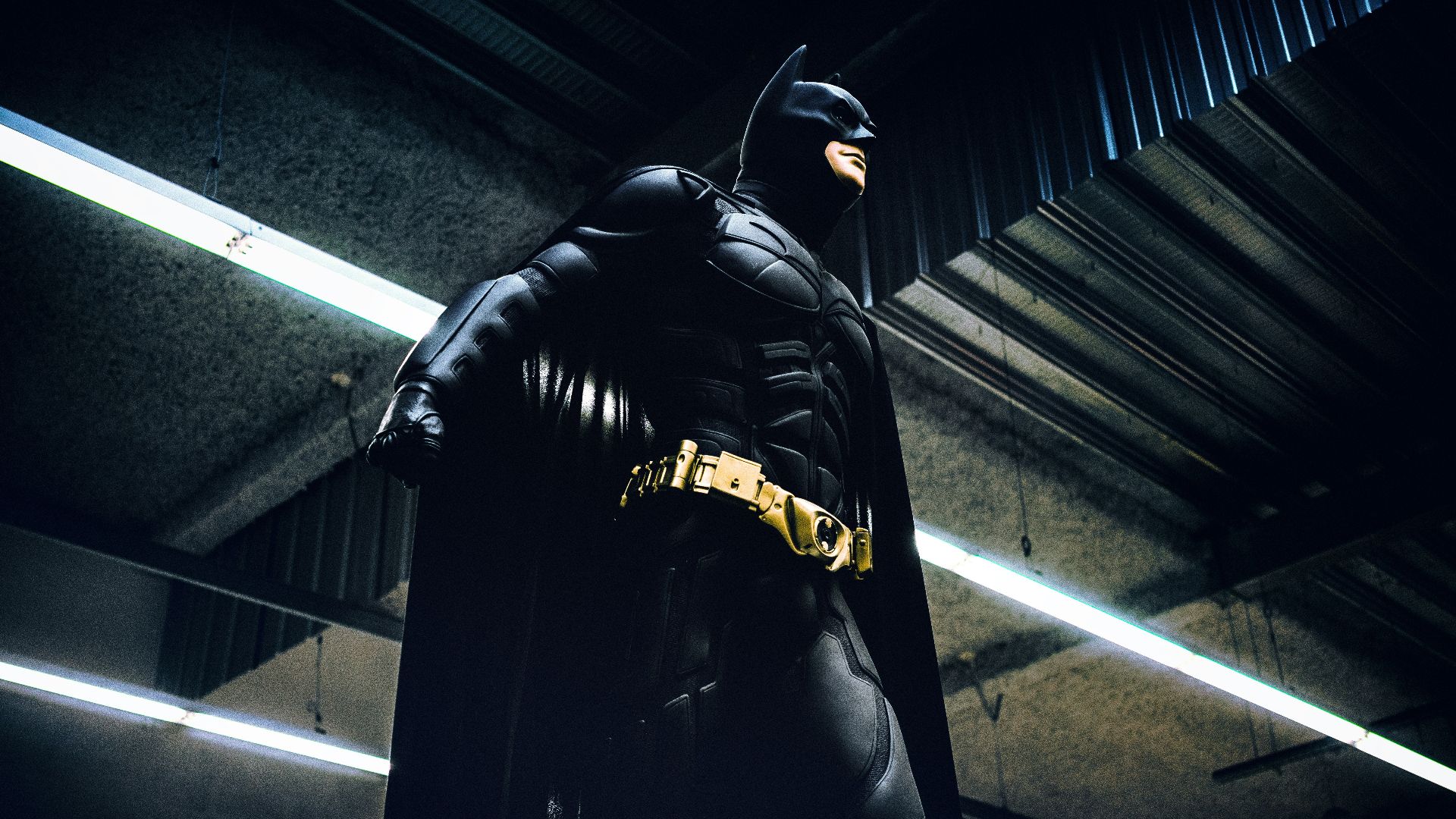 Batman standing under steel roof