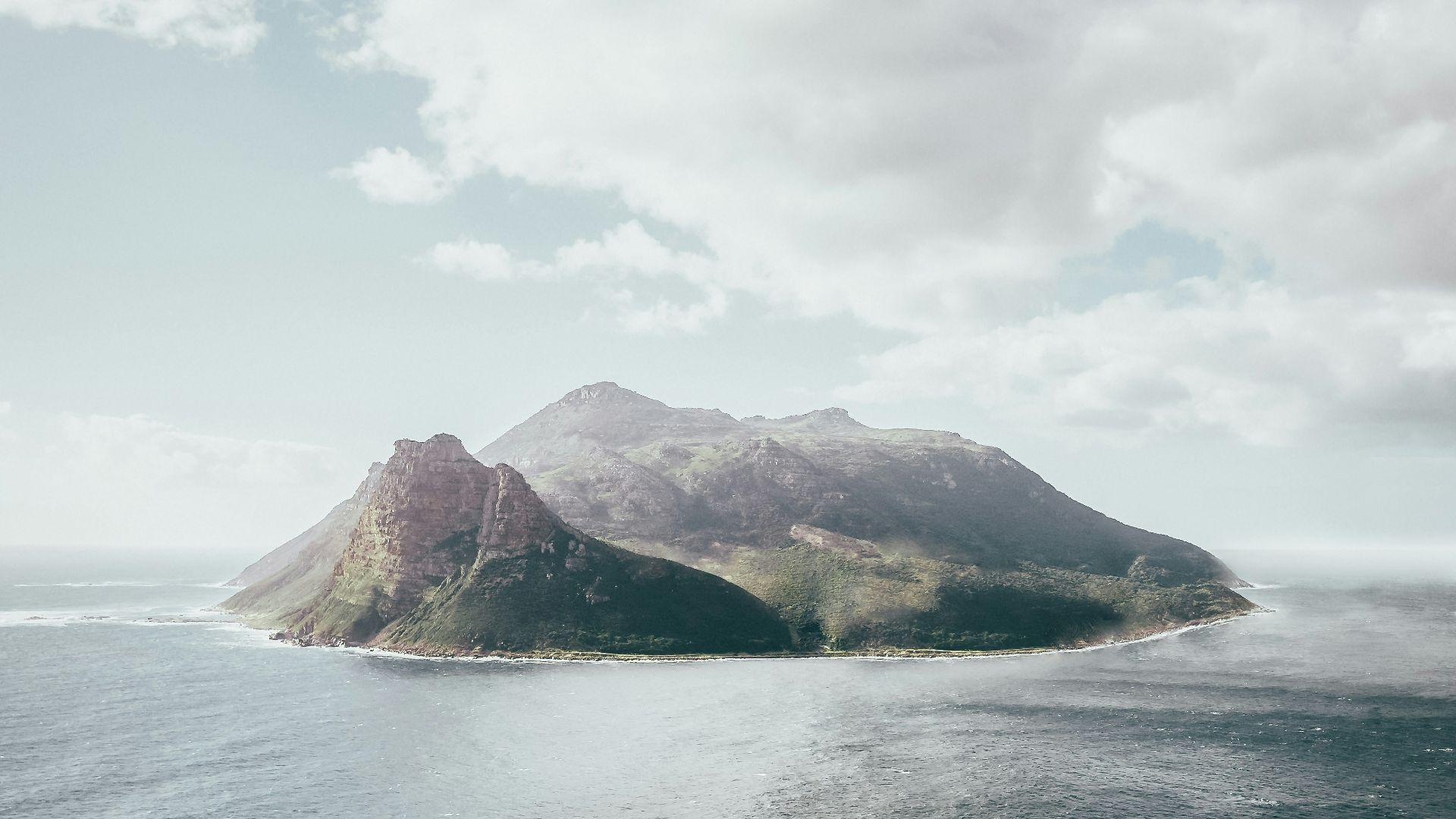 bird's eye view photography of island under white clouds
