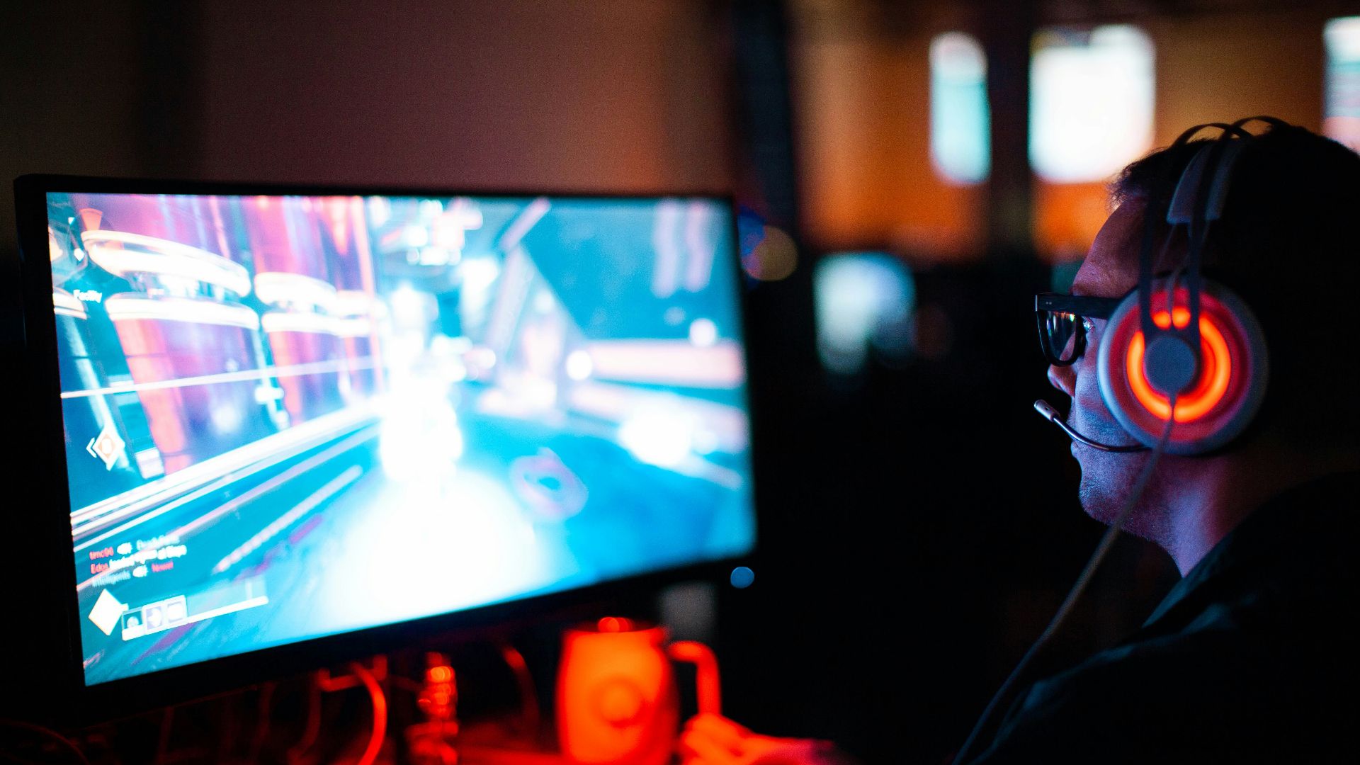 person using computer playing FPS game