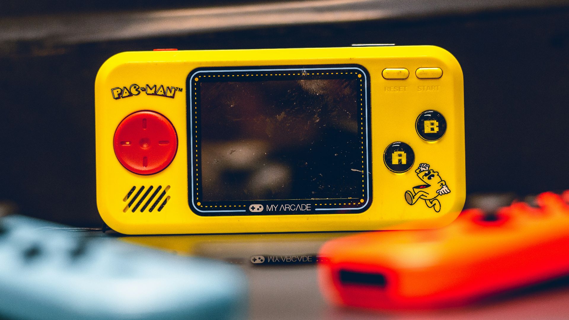 a yellow gameboy sitting on top of a table