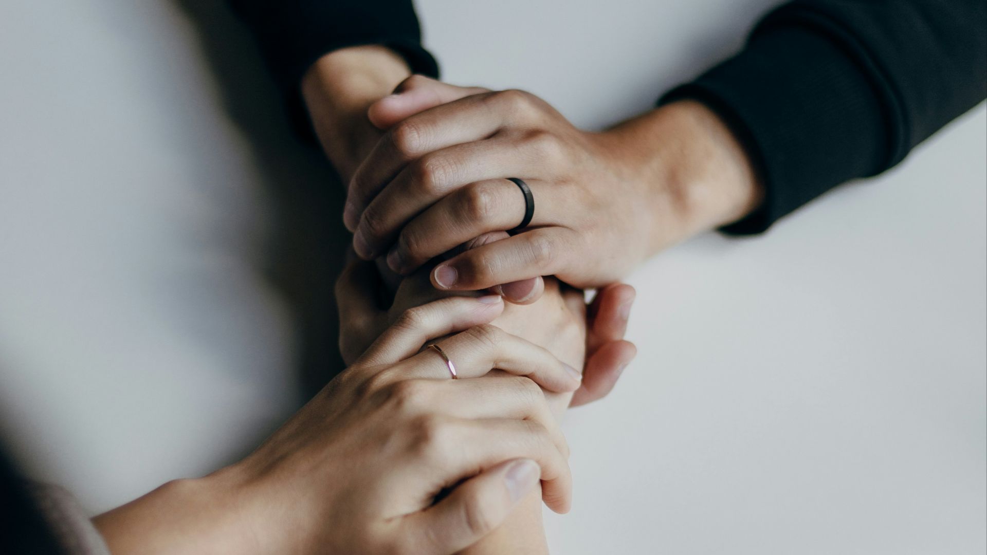 person in black long sleeve shirt holding babys feet