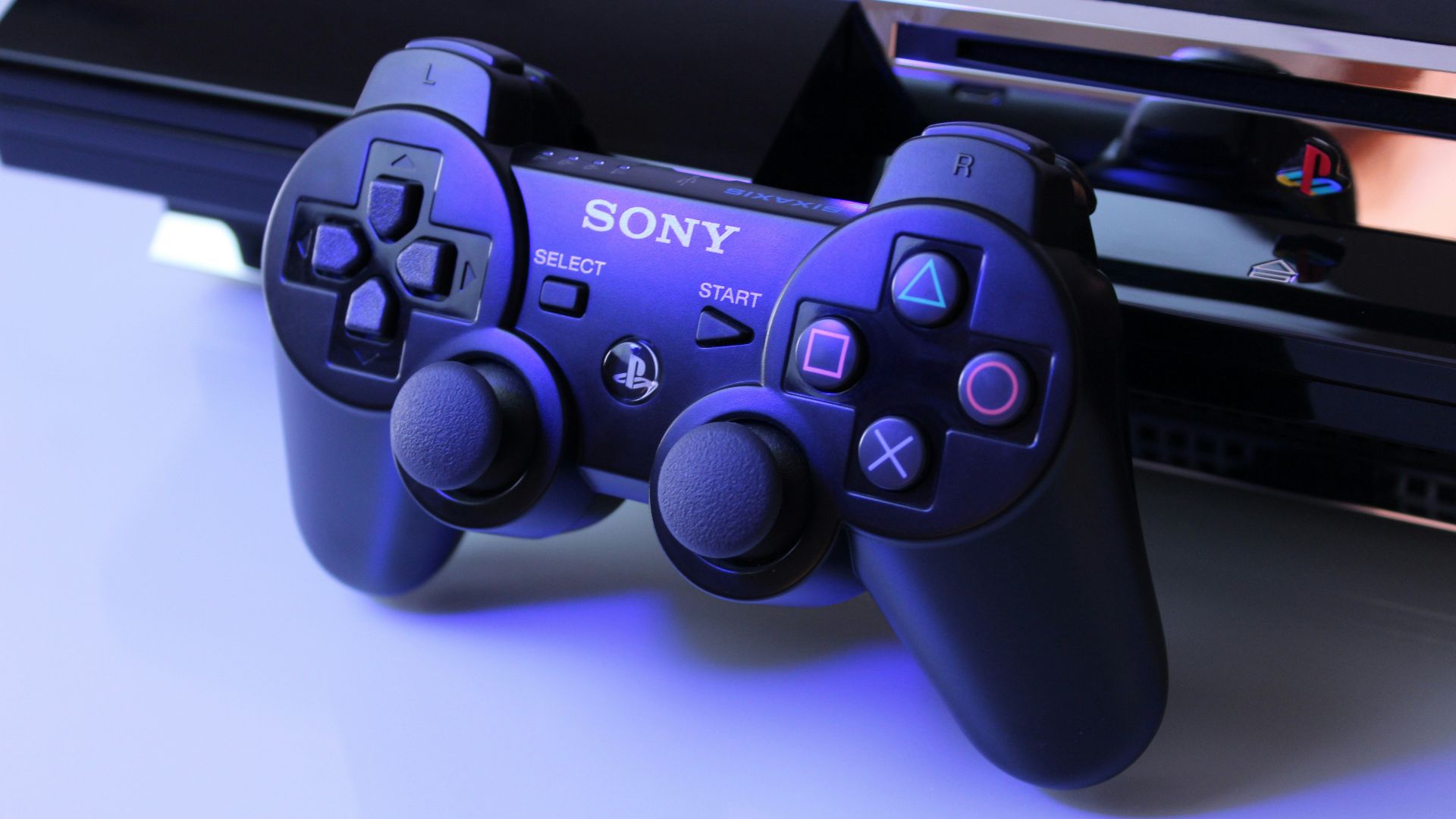 black Sony PS2 controller on white surface