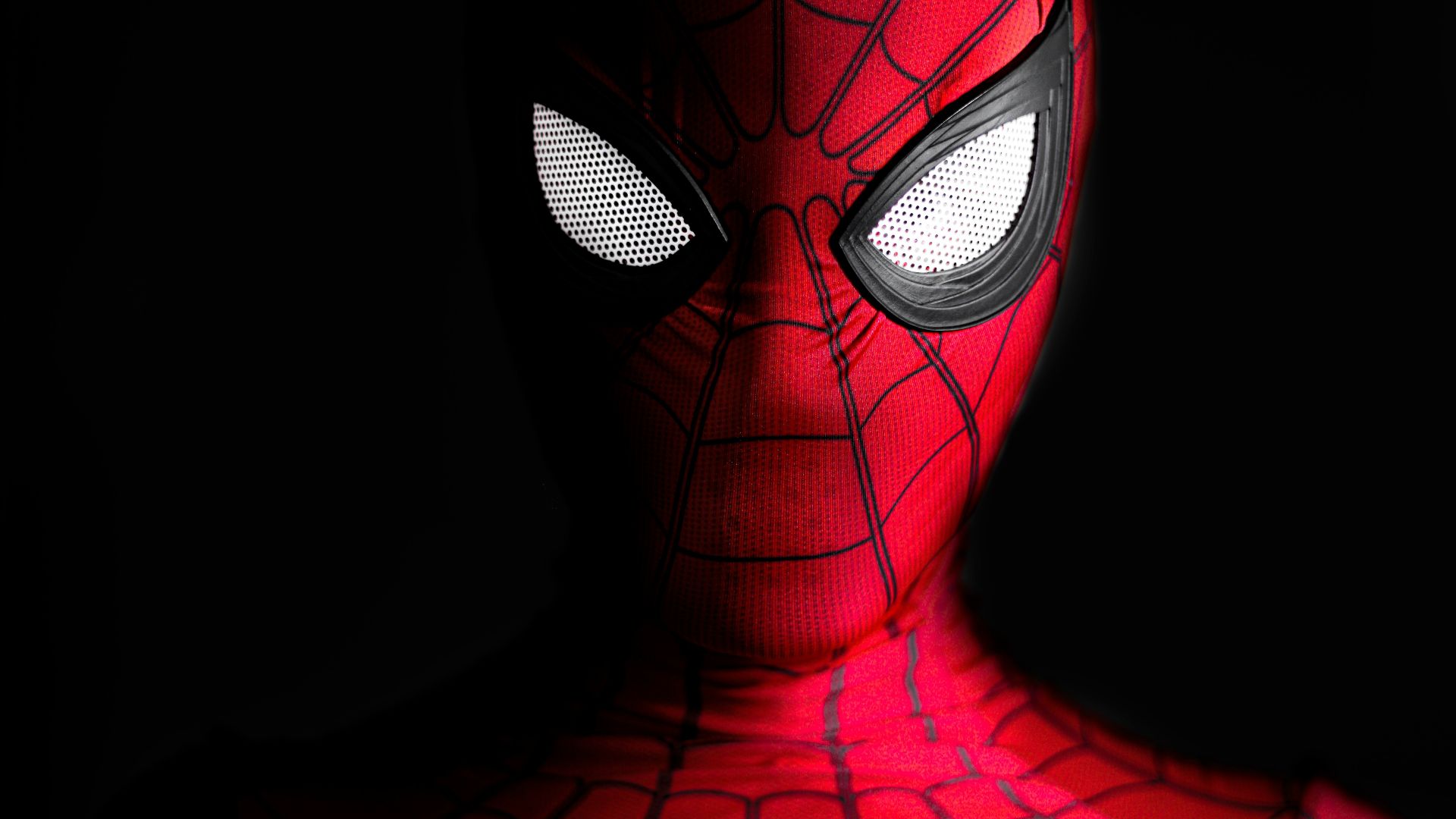 a close up of a spider man with glowing eyes