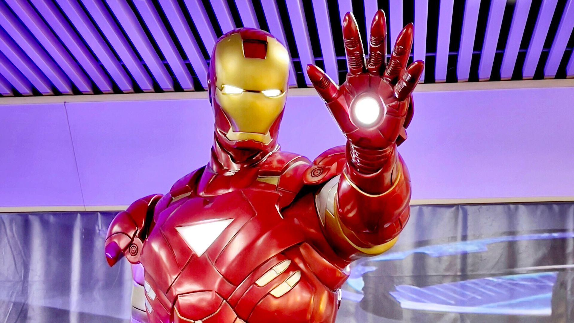 a statue of iron man is displayed in a museum