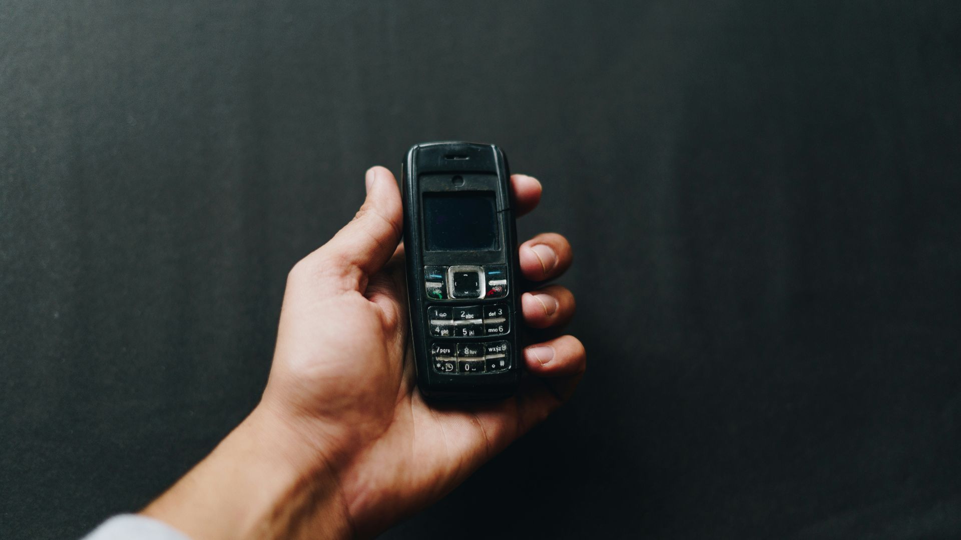 person holding black nokia candy bar phone