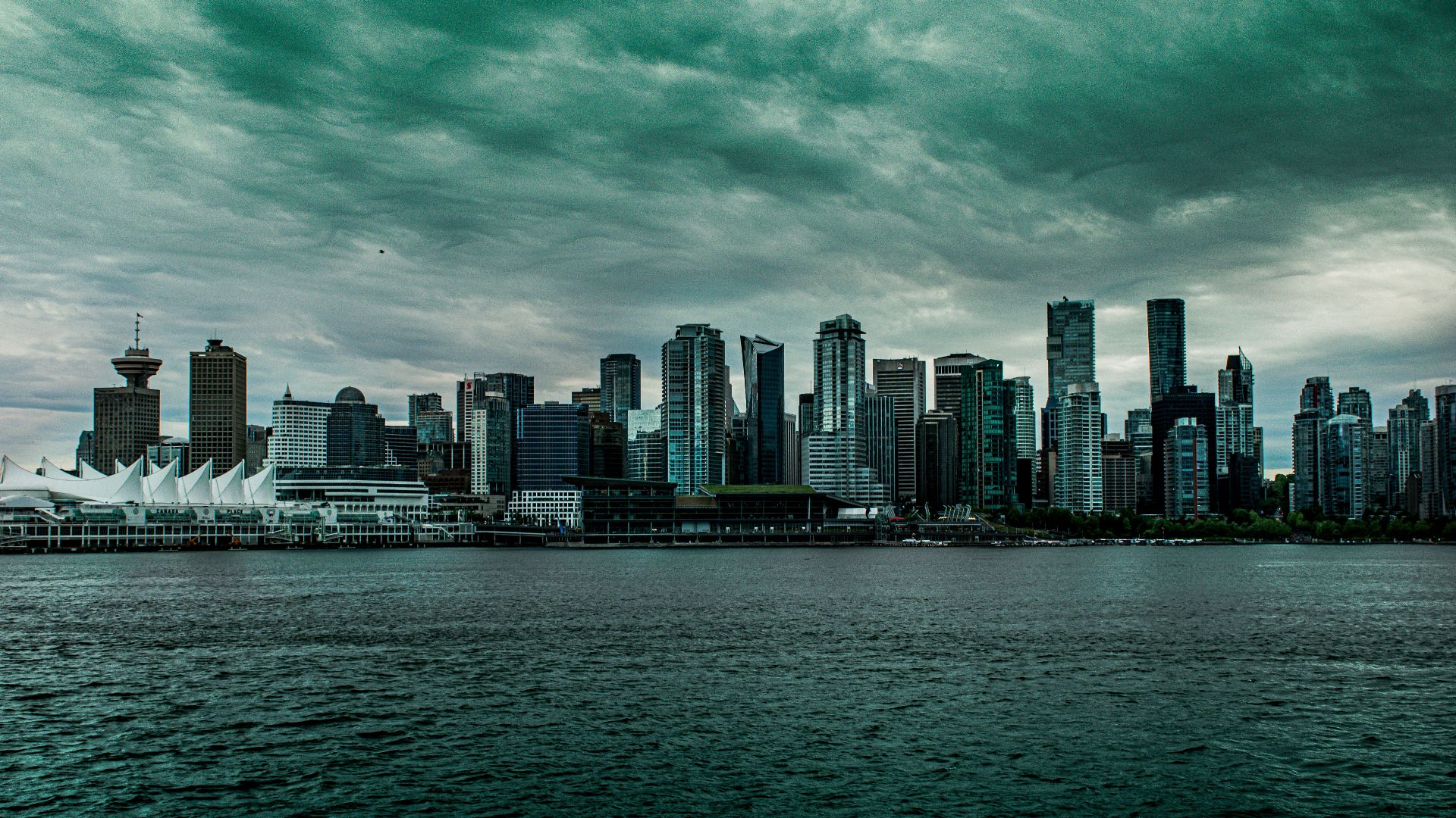 city skyline across body of water during daytime