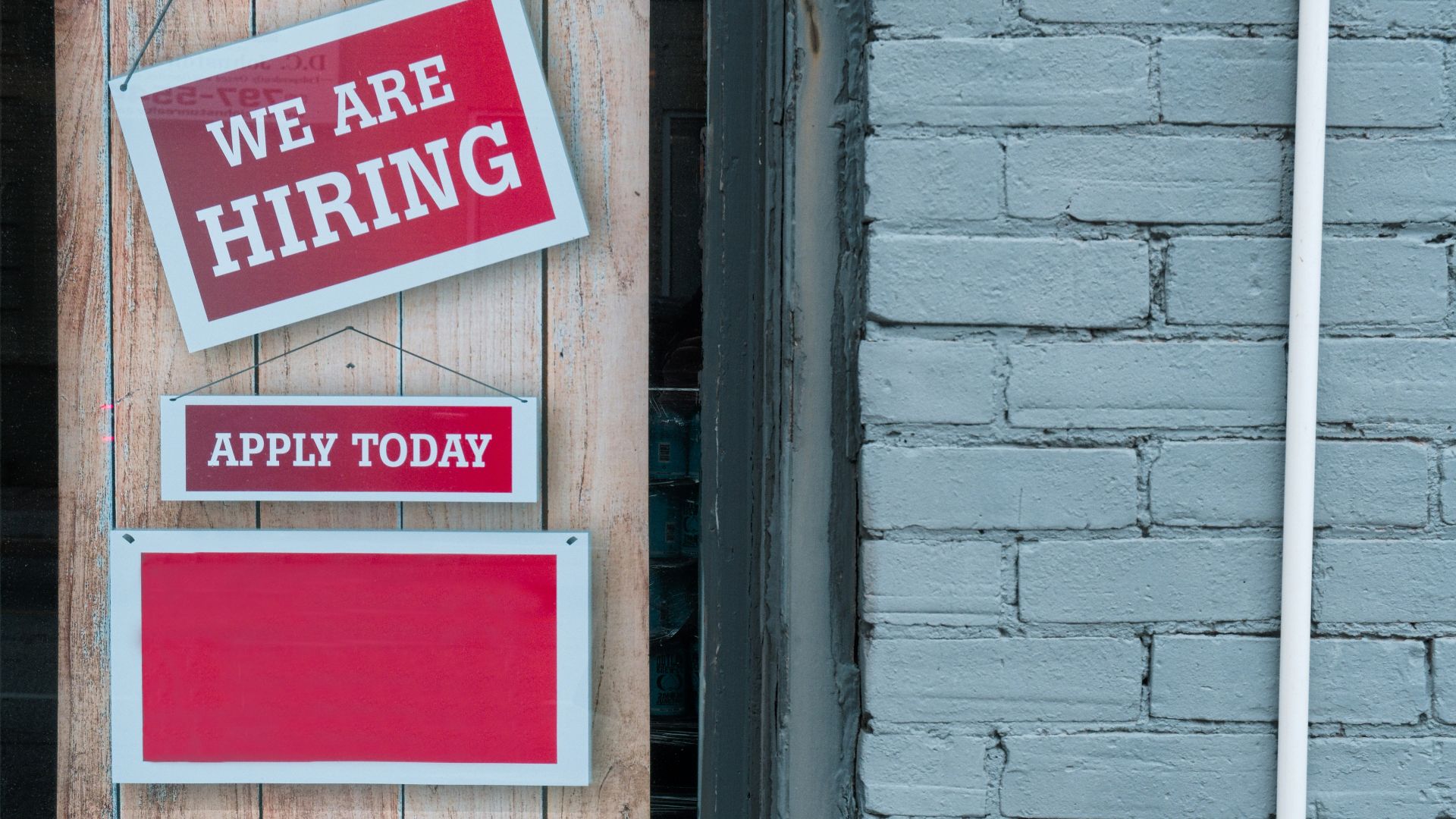 a sign that says we are hiring and apply today