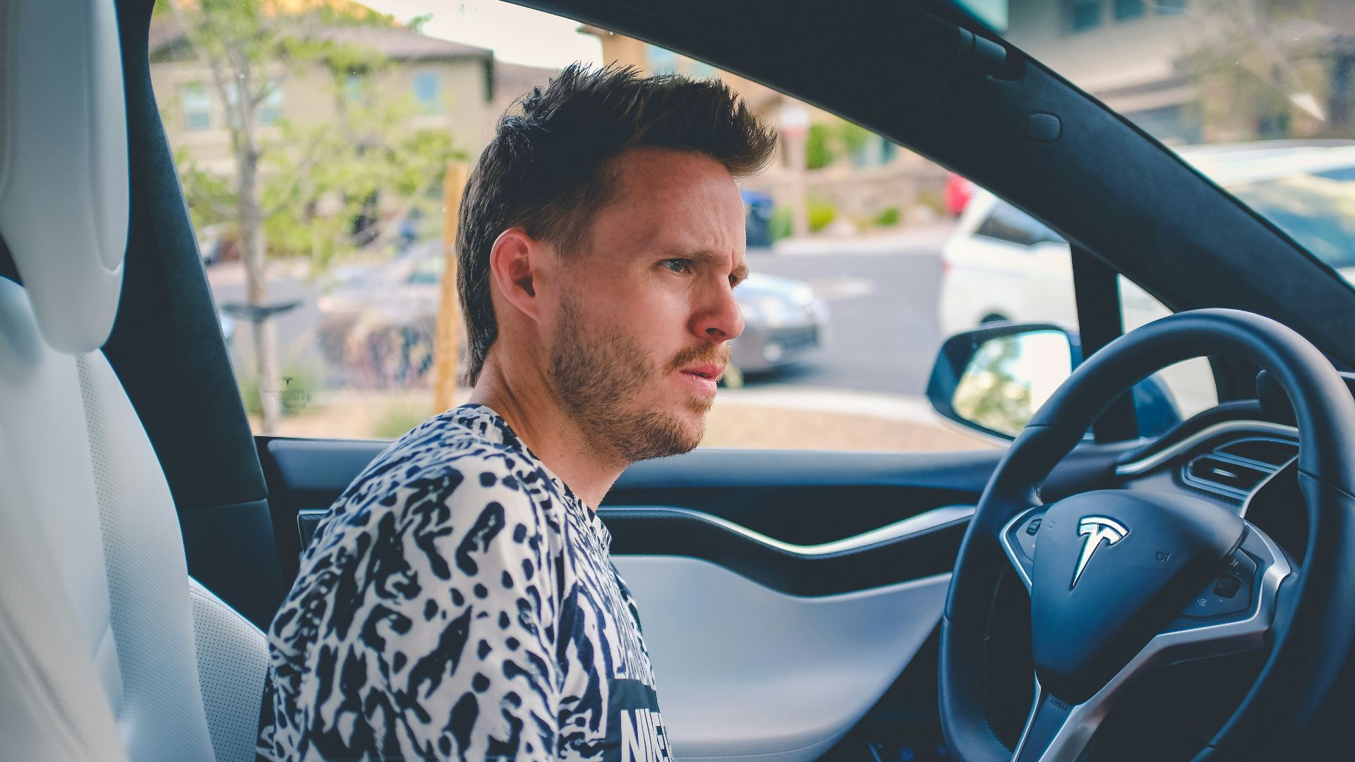 man sitting on car front seat