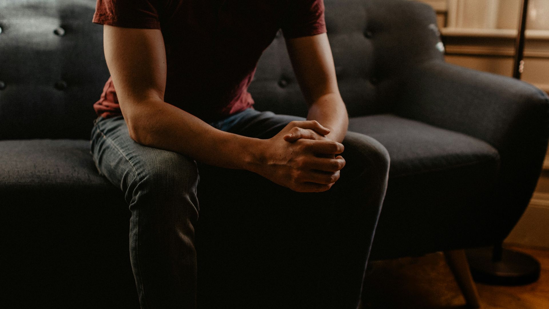 man sitting on sofa