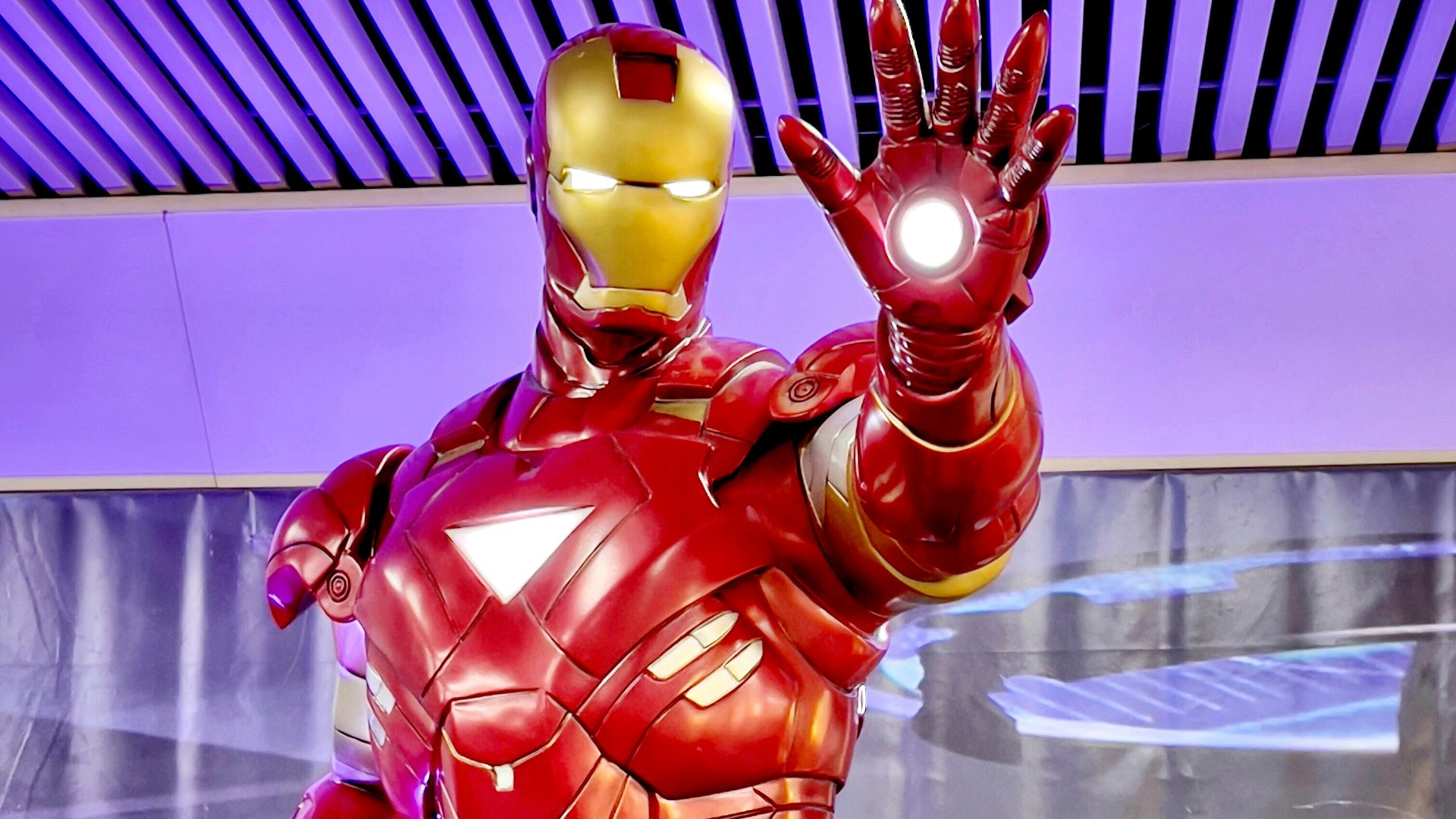 a statue of iron man is displayed in a museum