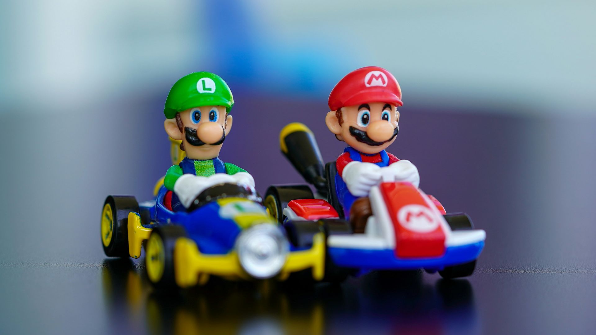 lego mini figure riding blue and red toy car