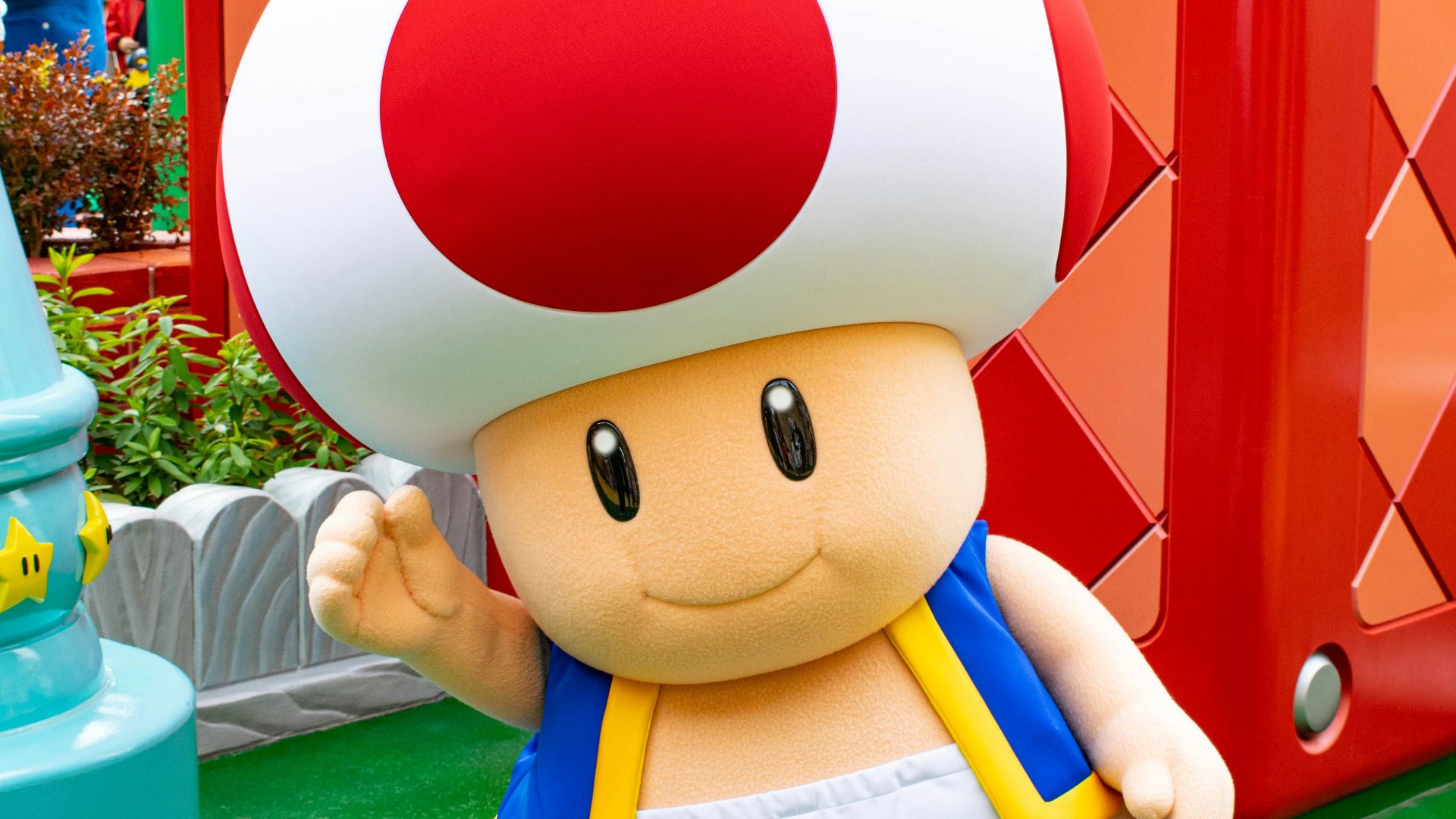 boy in blue and white shirt holding red and white balloon