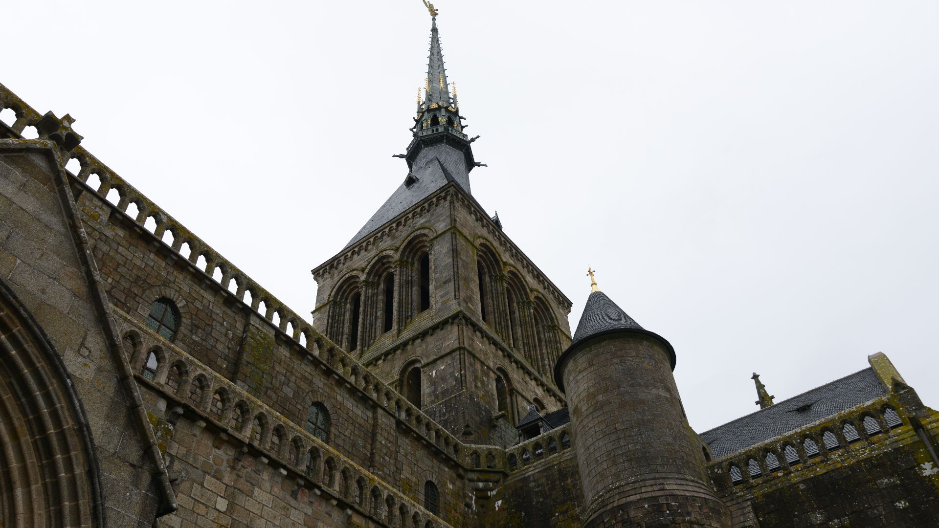 File:The Archangel Michael slaying the dragon of the Apocalypse to the top of the spire of the abbey - Mont St Michel (32800253421).jpg