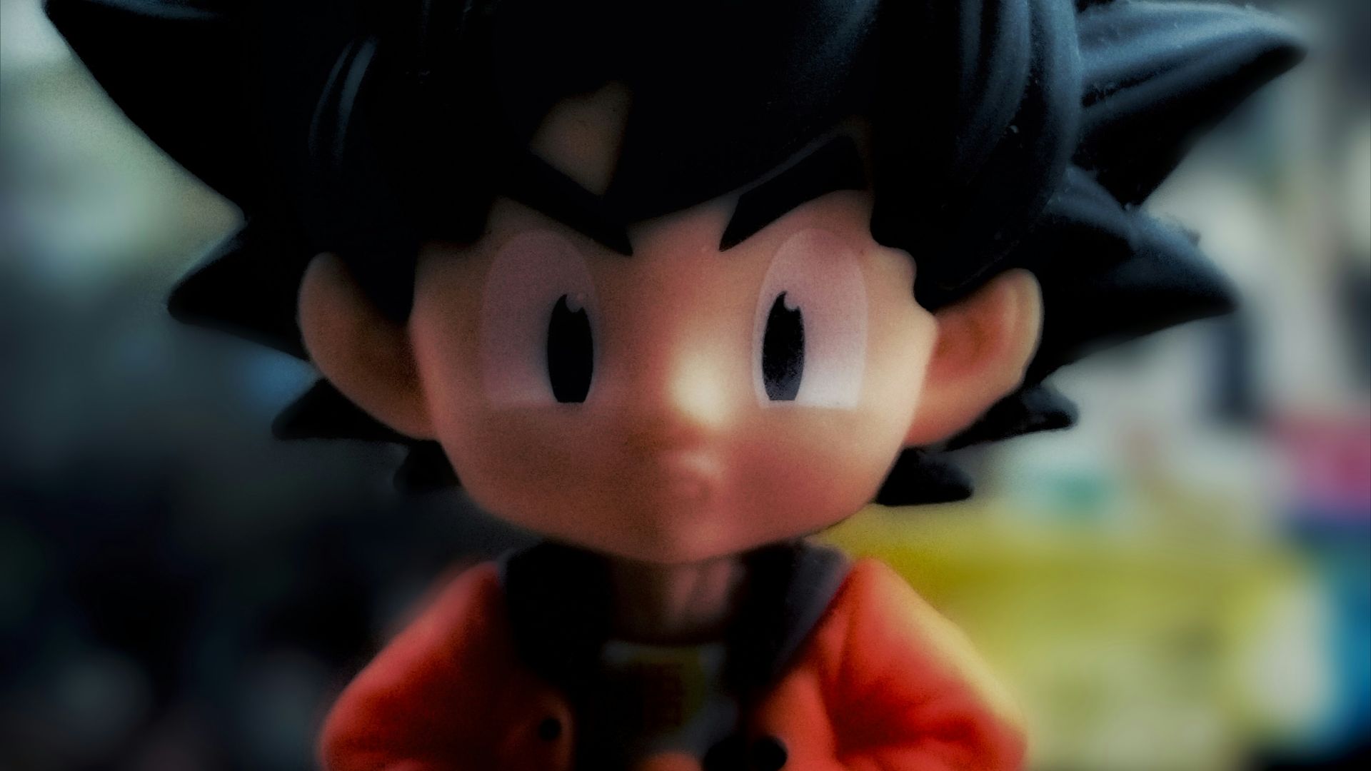 A close up of a toy of a boy with black hair