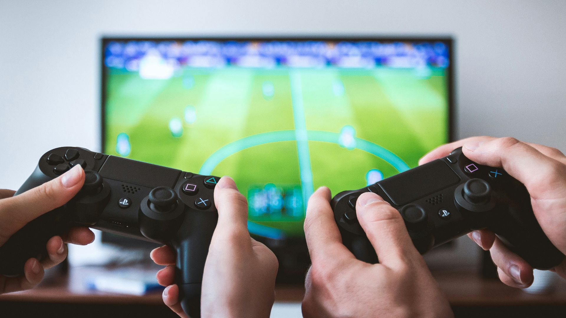 two people playing Sony PS4 game console