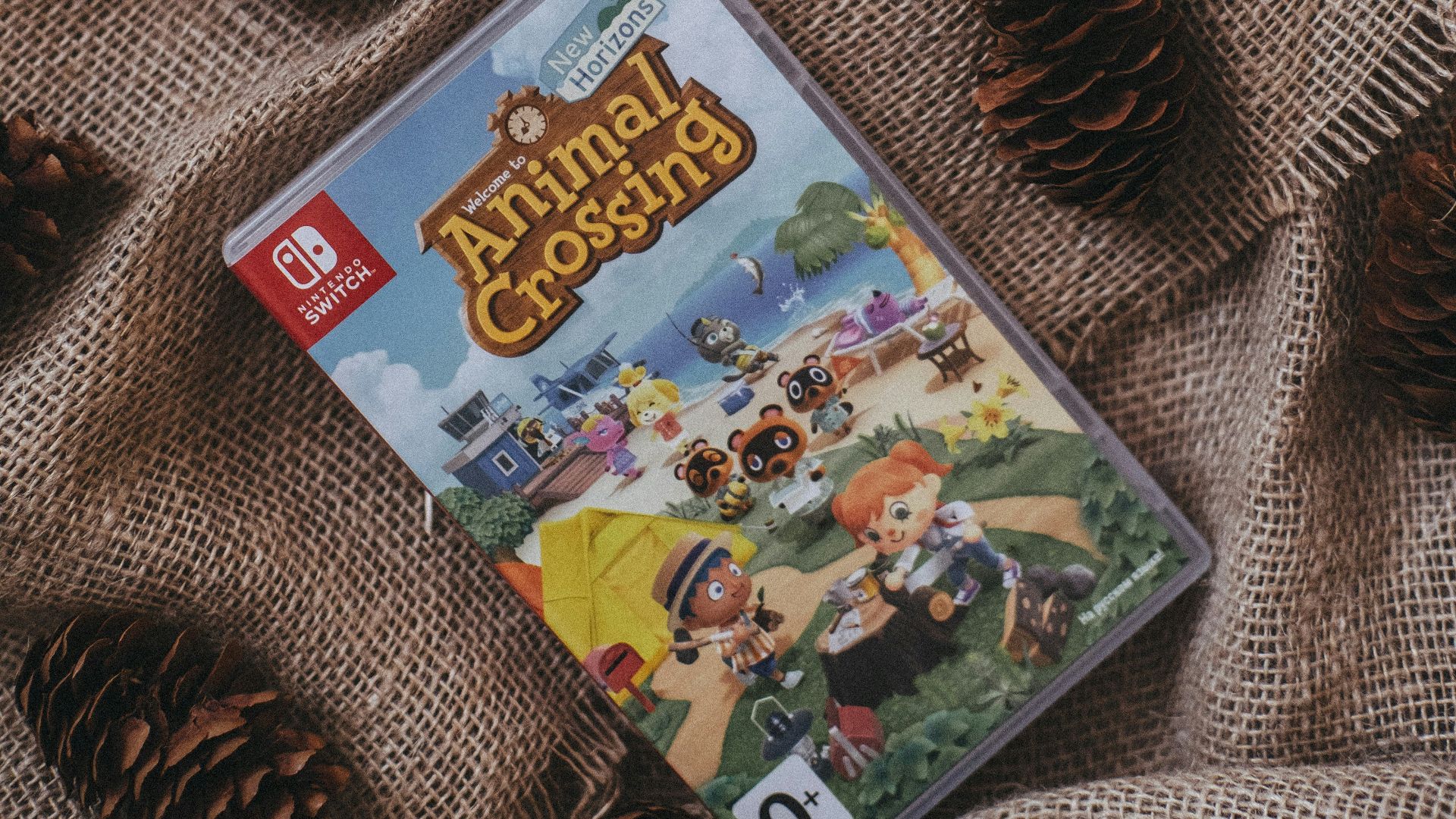 a nintendo wii game sitting on top of a blanket