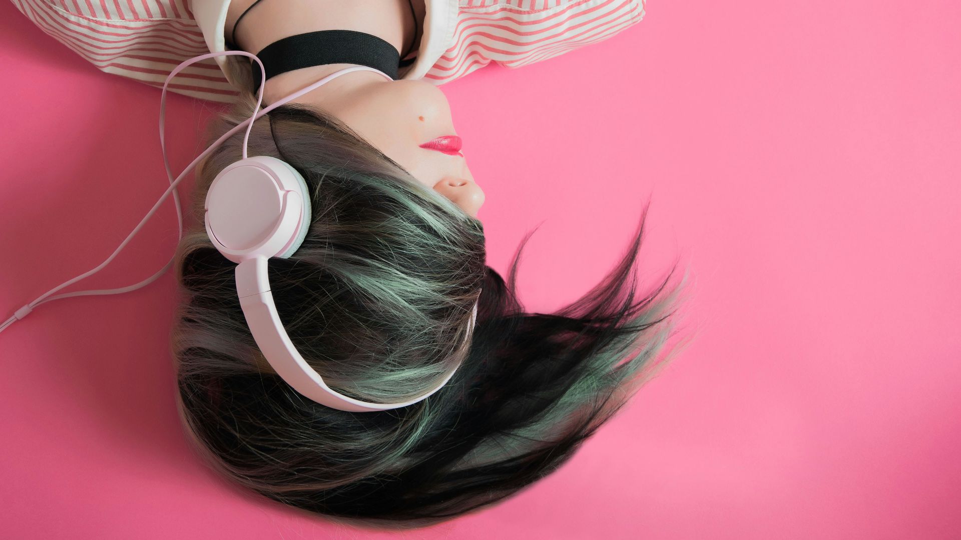 woman covering her hair and wearing headphones