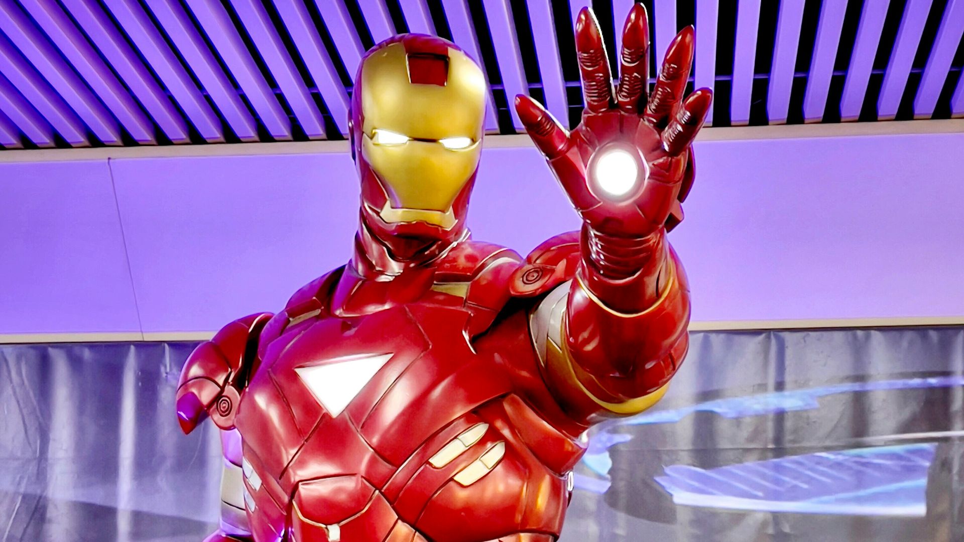 a statue of iron man is displayed in a museum