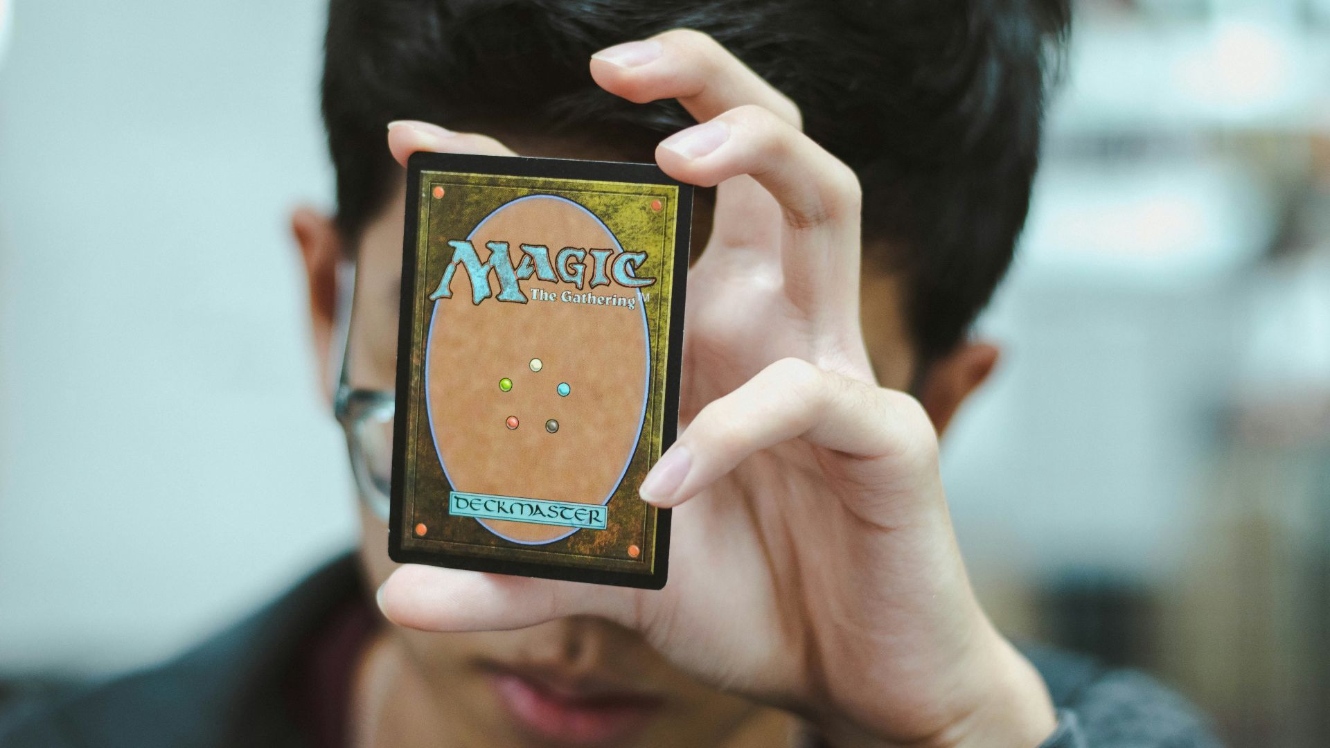 boy holding Magic: The Gathering trading card