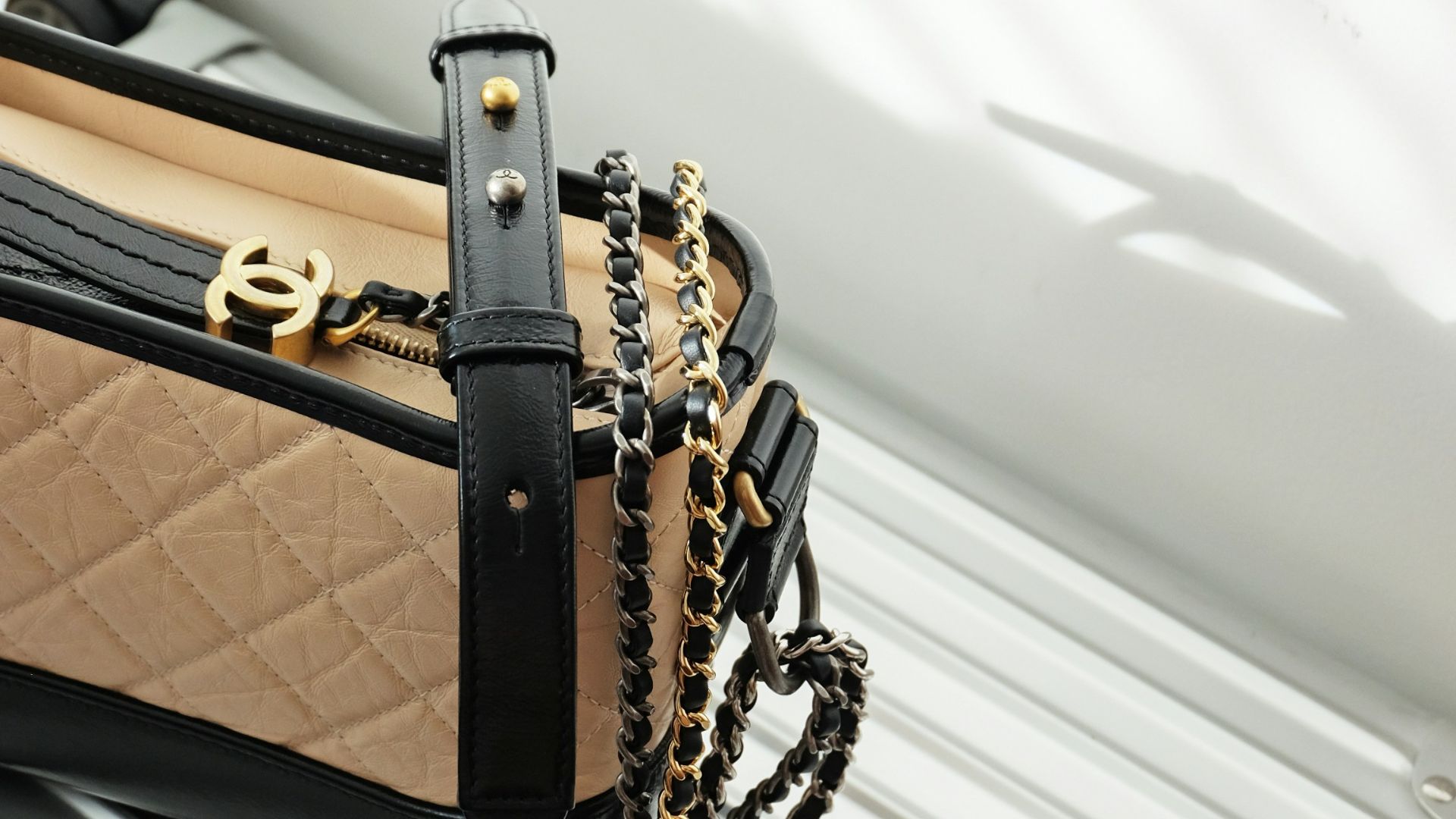 brown and black leather sling bag