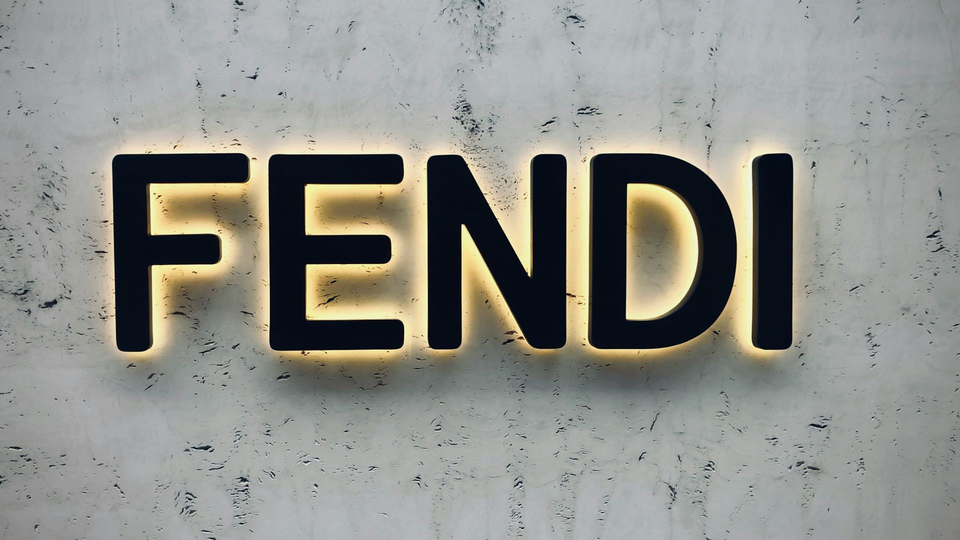 the word fendi spelled with neon lights on a wall
