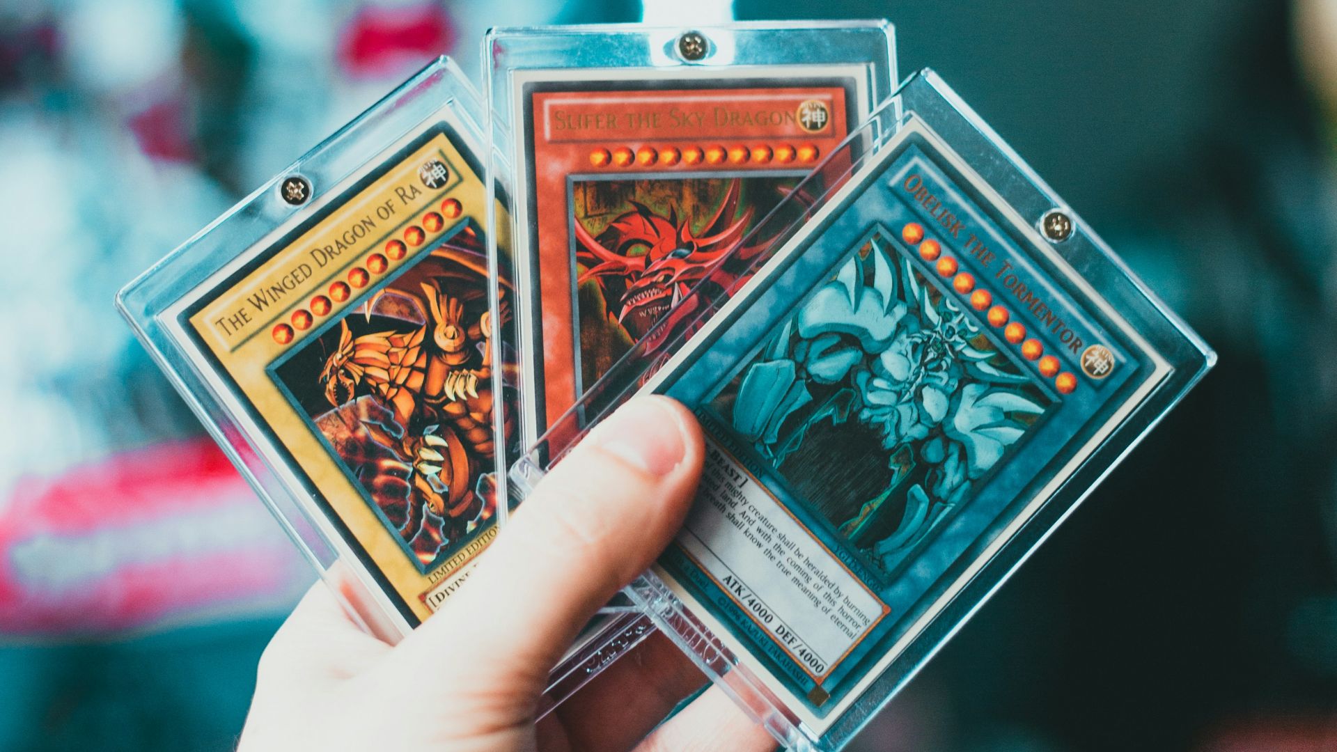 person holding red and white playing card