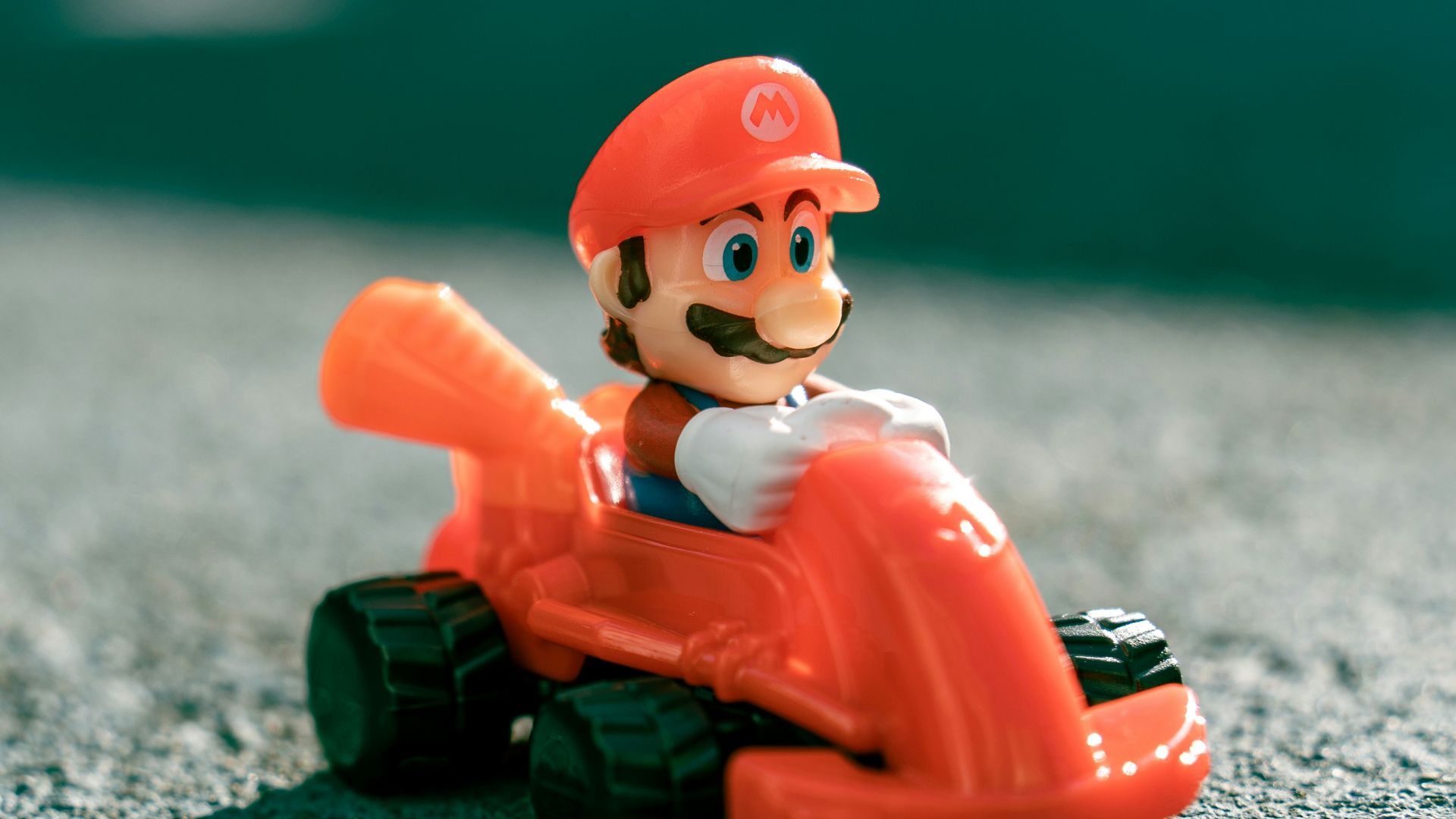 a small toy of a man riding a toy car